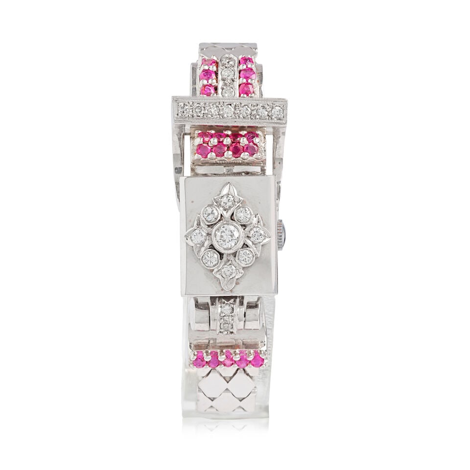 Emil Leichter. A lady's 14K white gold diamond and ruby set manual wind bracelet watch with conc...: Emil Leichter. A lady's 14K white gold diamond and ruby set manual wind bracelet watch with concealed dial Date: Circa 1950 Movement: 17-jewel manual wind Dial: Silvered Case: Polished rectangular