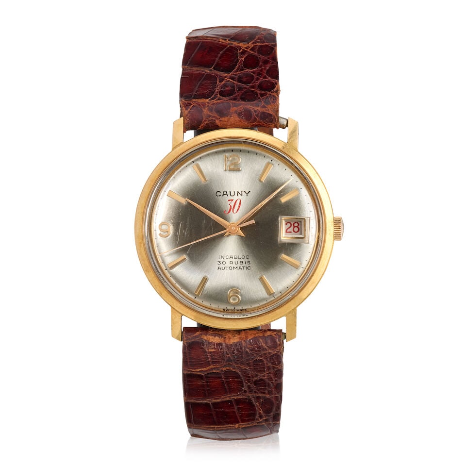 Cauny. An 18K gold automatic calendar wristwatchRef: 2452, Circa 1975: Cauny. An 18K gold automatic calendar wristwatch Reference: 2452 Date: Circa 1975 Movement: Jewelled Dial: Sunburst silvered, applied gilt markers Case: Polished round, No.295 6279 Strap/Bracelet: