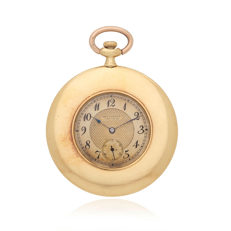 Mediansky Carlsbad. An 18K gold open face keyless wind pocket watchCirca 1900: Mediansky Carlsbad. An 18K gold open face keyless wind pocket watch Date: Circa 1900 Movement: Swiss lever, No.2227356 Dial: Champagne Case: Polished round, No.2227356 Signed: Dial Size: 45mm For