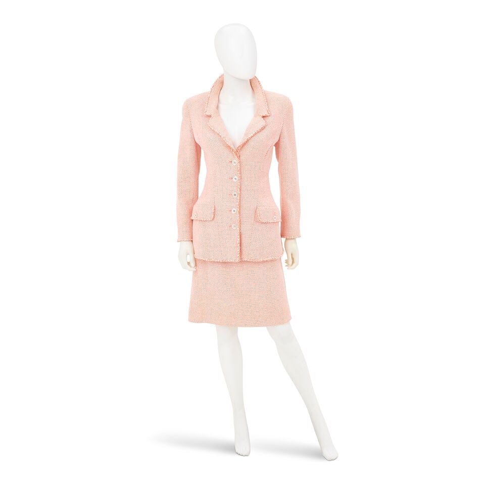 CHANEL: ORANGE AND WHITE TWEED SKIRT SUIT ENSEMBLE Spring 1997: CHANEL: ORANGE AND WHITE TWEED SKIRT SUIT ENSEMBLE Spring 1997 • Orange and White Cotton Tweed Blend Exterior • Rope Trim Detail Throughout • Simulated Mother of Pearl CC Button Clos