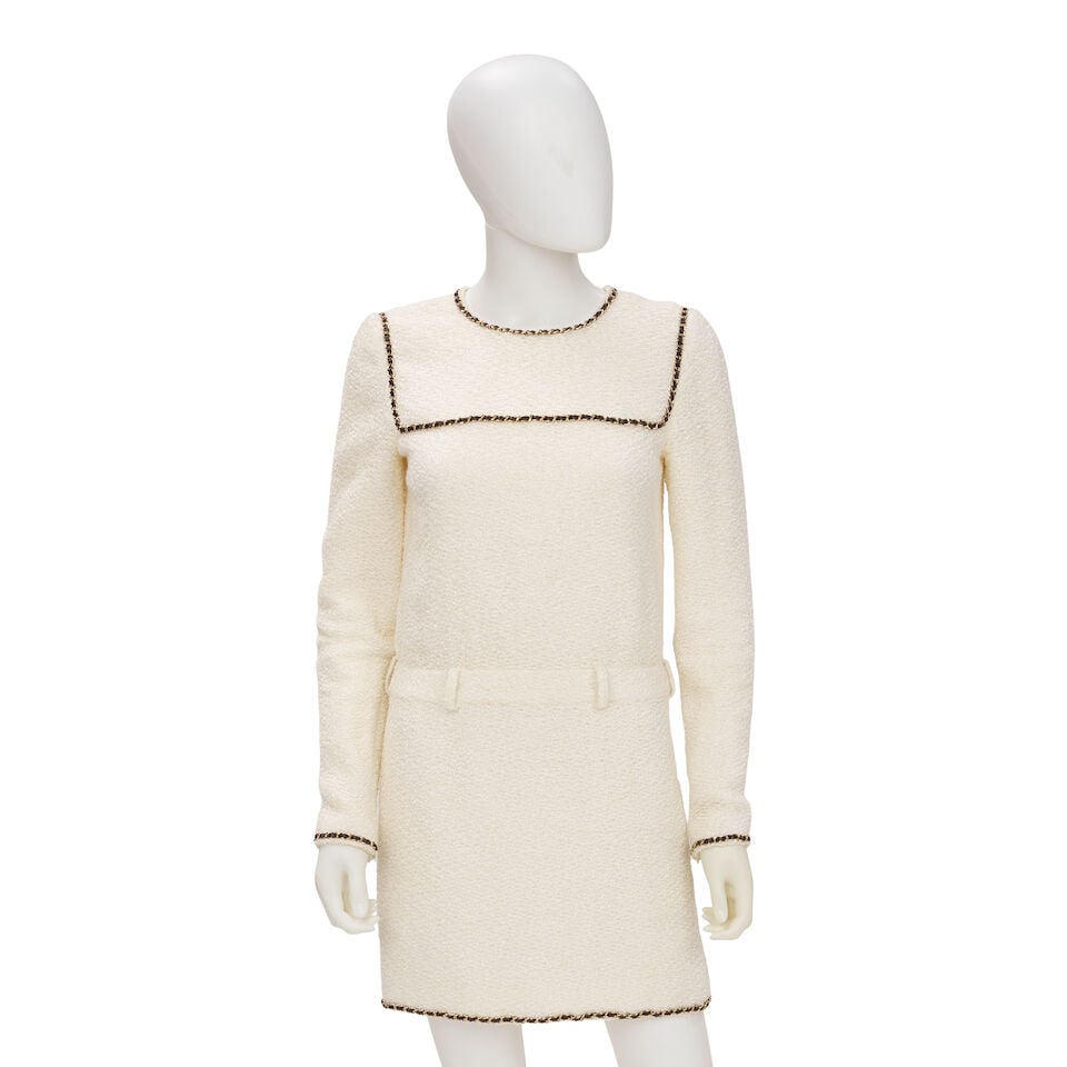 CHANEL: WHITE TWEED CHAIN AROUND DRESS Fall 2019: CHANEL: WHITE TWEED CHAIN AROUND DRESS Fall 2019 • Marked Size 36 • White Tweed Exterior with Leather Chain Detail • Zip Closure Footnotes: Archival Notes: • Design apart of Ka
