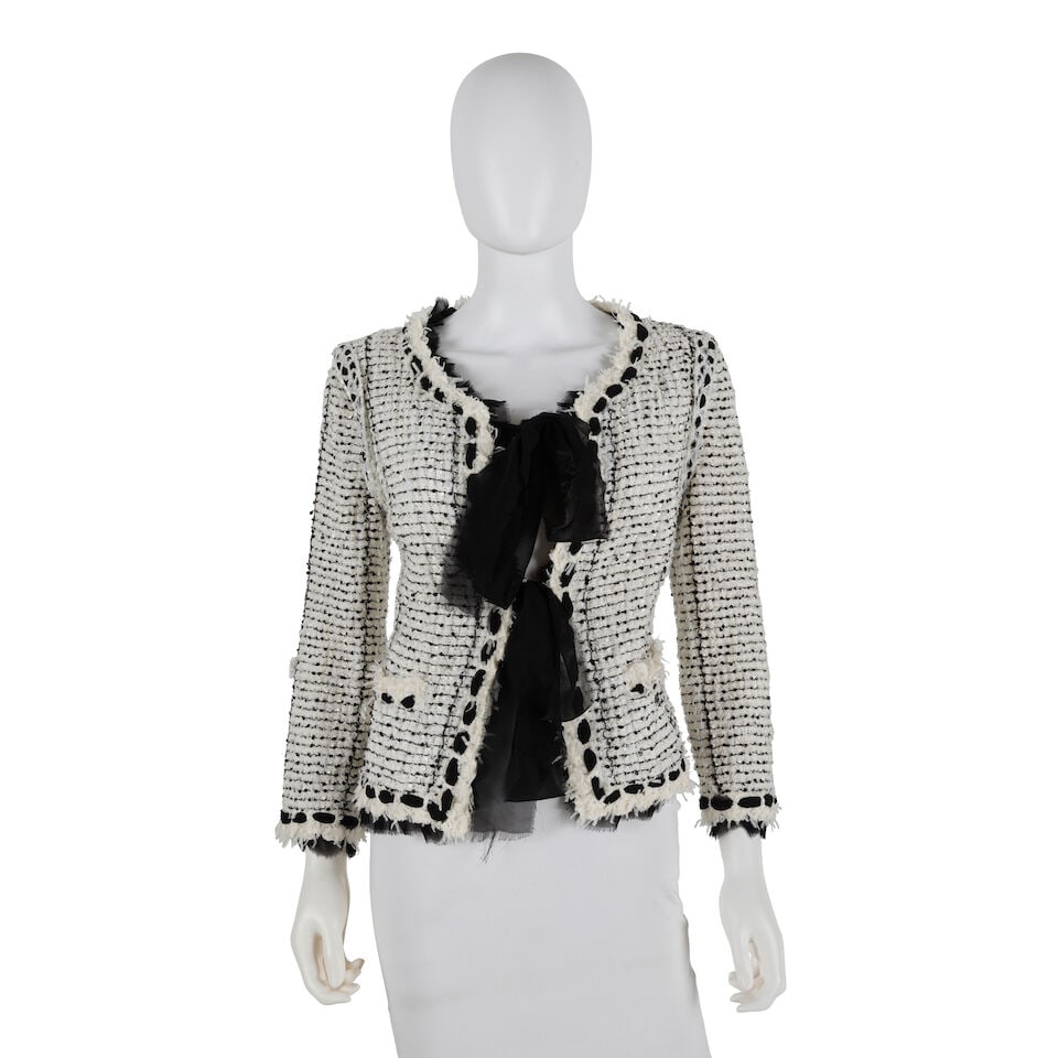 CHANEL: WHITE AND BLACK TWEED JACKET WITH RIBBON TIE Spring 2005: CHANEL: WHITE AND BLACK TWEED JACKET WITH RIBBON TIE Spring 2005 • Black and White Tweed Exterior with Sequins Throughout • Fringe and Ribbon Embellishments Along Trim • Black Ribbon