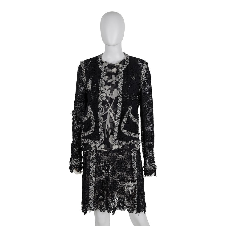 CHANEL: BLACK AND WHITE LACE CAMELLIA SKIRT SUIT ENSEMBLE Spring 2004: CHANEL: BLACK AND WHITE LACE CAMELLIA SKIRT SUIT ENSEMBLE Spring 2004 • Including Black Lace Jacket, Silk Chiffon Blouse, and Black Lace Skirt • Camellia Motif Throughout • Flower Fr