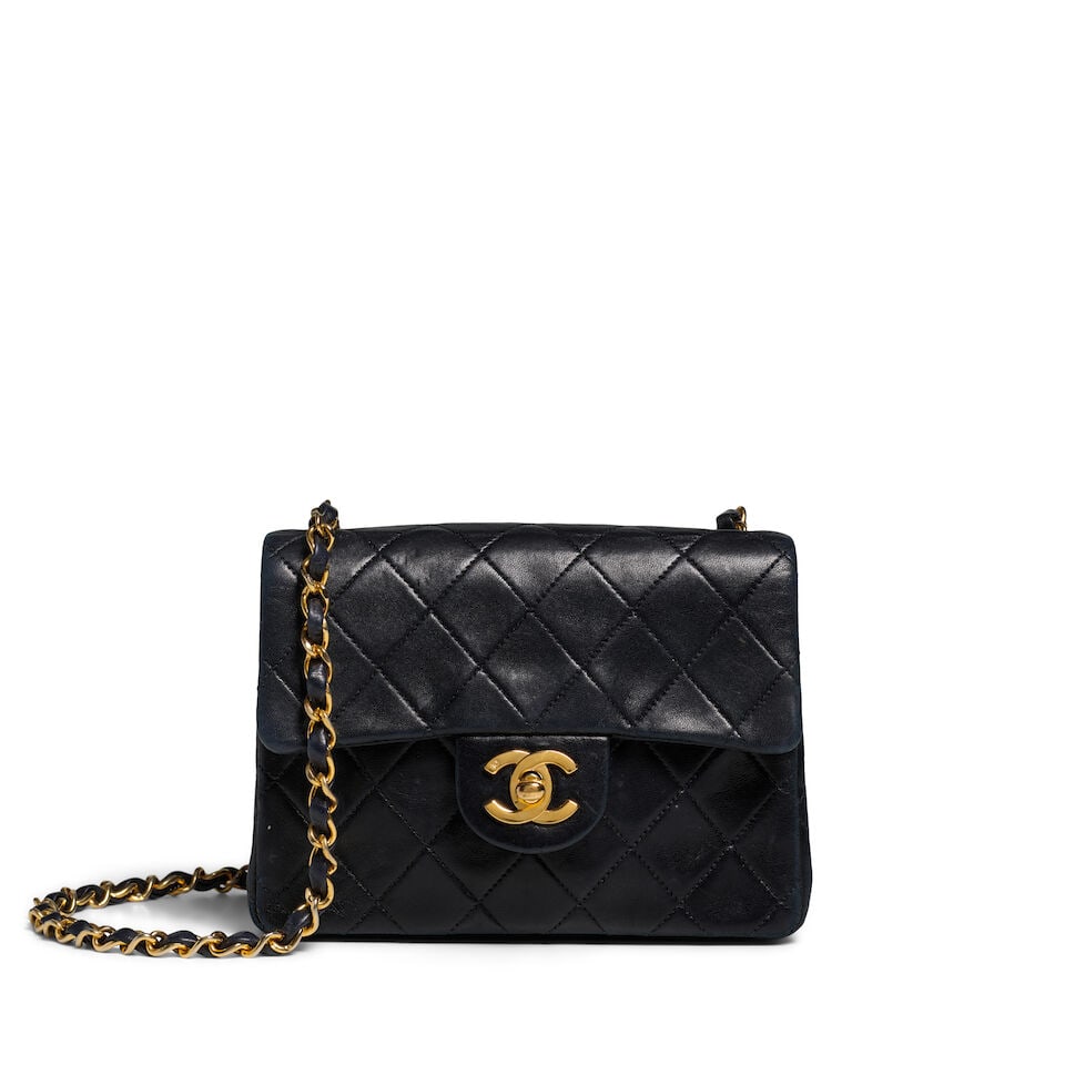 CHANEL: NAVY SQUARE MINI FLAP BAG 1991-1994: CHANEL: NAVY SQUARE MINI FLAP BAG 1991-1994 • Black Quilted Lambskin Leather Exterior • Gold Tone Hardware • Leather and Chain Shoulder Strap • Exterior Patch Pocket • CC