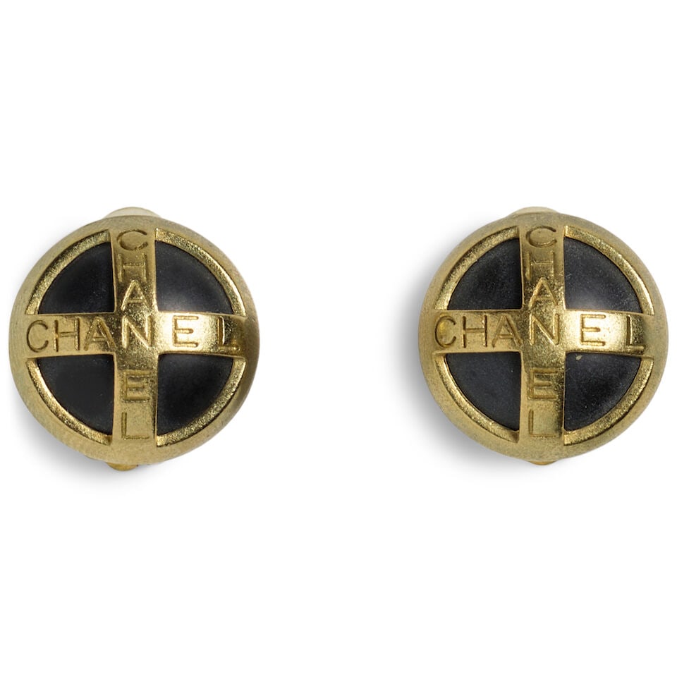 CHANEL: BLACK AND GOLD ROUND LOGO EARRINGS Fall 1994: CHANEL: BLACK AND GOLD ROUND LOGO EARRINGS Fall 1994 • Black Enamel and Gold-Tone Metal with Chanel Engraving Detail • Clip On Closure • Includes Box • Measures: 2.25 cm x 2.25
