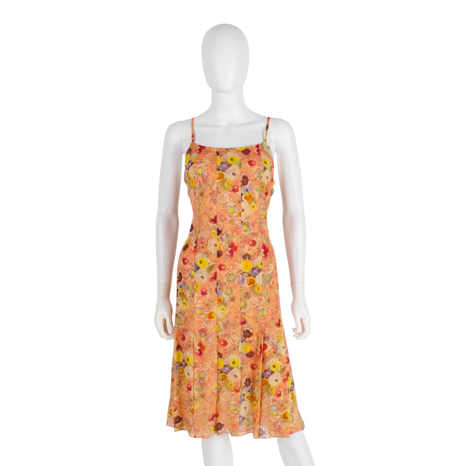 CHANEL: ORANGE CAMILLA PRINT MIDI SILK DRESS Spring 2004: CHANEL: ORANGE CAMILLA PRINT MIDI SILK DRESS Spring 2004 • Orange Multicolor Camilla and CC Print Silk Chiffon Exterior • Zipper Closure • Pleated Detail at Botton • Beige Inte