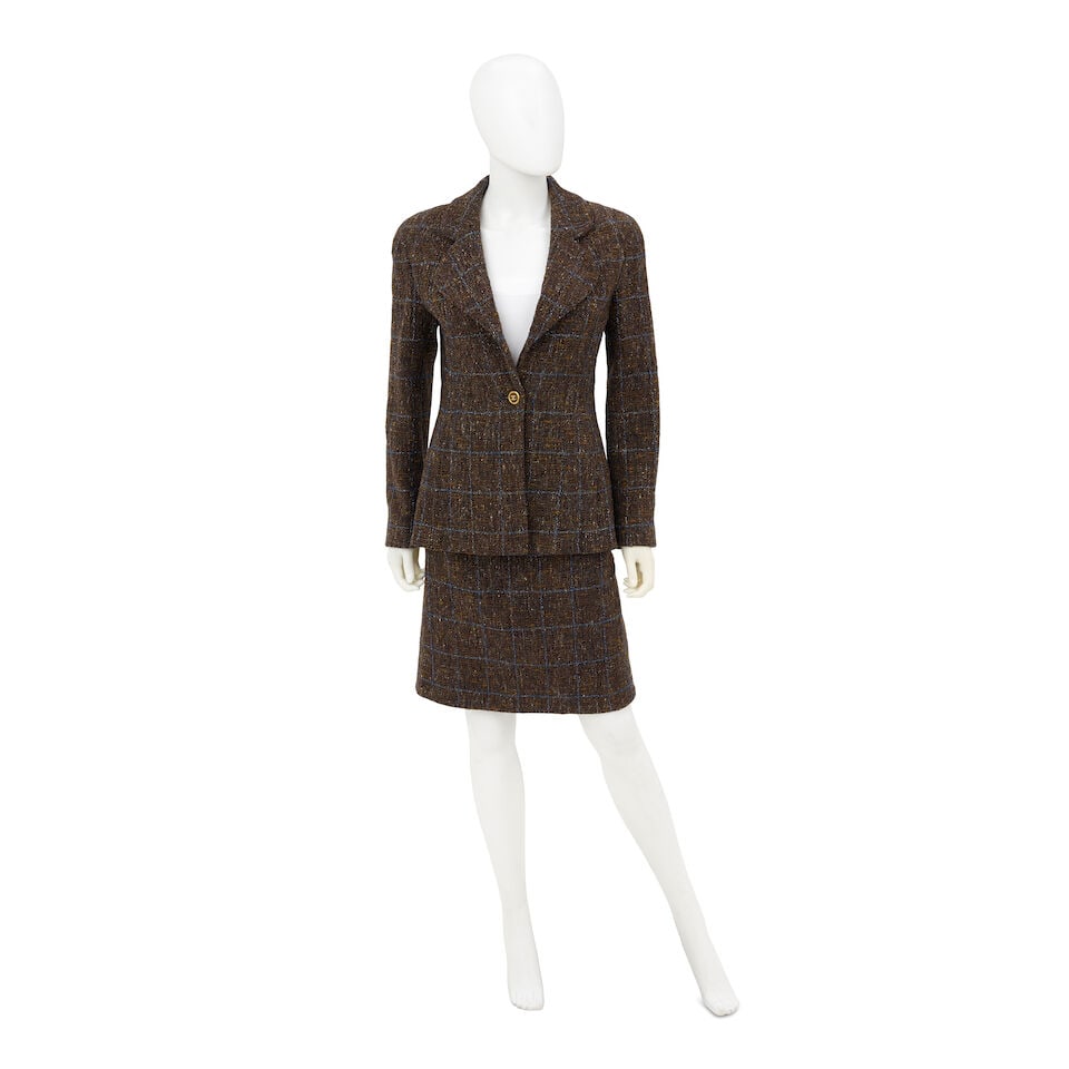 CHANEL: BROWN AND BLUE LUREX TWEED SKIRT SUIT ENSEMBLE Fall 1994: CHANEL: BROWN AND BLUE LUREX TWEED SKIRT SUIT ENSEMBLE Fall 1994 • Multicolor Brown, Yellow and Rust Wool Exterior • Blue Lurex Check Pattern Detail Throughout • Single Button Brown 