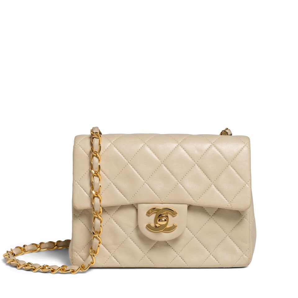 CHANEL: CREAM LAMBSKIN MINI SQUARE FLAP Pre 1982: CHANEL: CREAM LAMBSKIN MINI SQUARE FLAP Pre 1982 • Cream Quilted Lambskin Leather Exterior • Gold Tone Hardware • Leather and Chain Shoulder Strap • Exterior Patch Pocket ̶