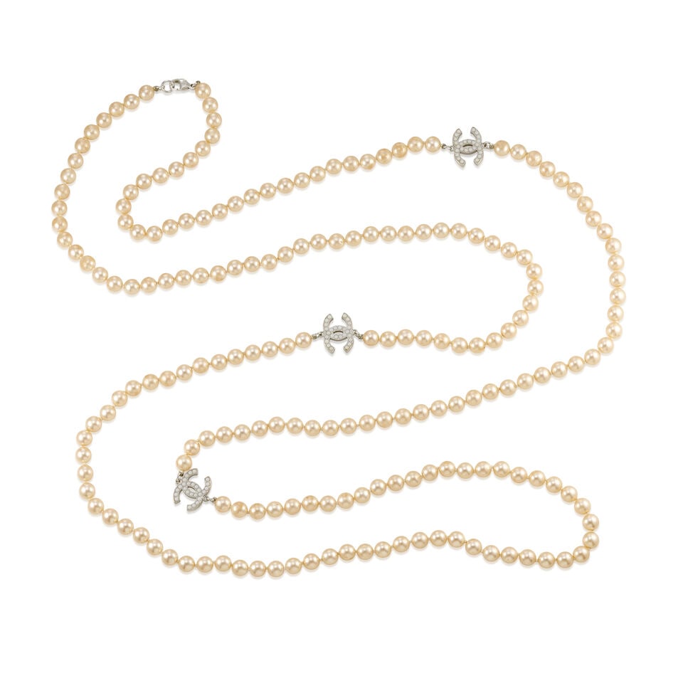 CHANEL: PEARL CC STRAND NECKLACE 2008: CHANEL: PEARL CC STRAND NECKLACE 2008 • Simulated Light Gold Pearls with White Gripoix Embellished CC Logo Detail • Lobster Clasp Closure • Measures 90cm Drop For further information