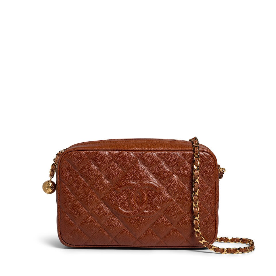 CHANEL: BROWN CAVIAR QUILTED CAMERA BAG 1994-1996: CHANEL: BROWN CAVIAR QUILTED CAMERA BAG 1994-1996 • Brown Caviar Quilted Exterior with CC Detail • Gold Tone Hardware • Chain Shoulder Strap • Zipper Closure with Gold CC Ball 