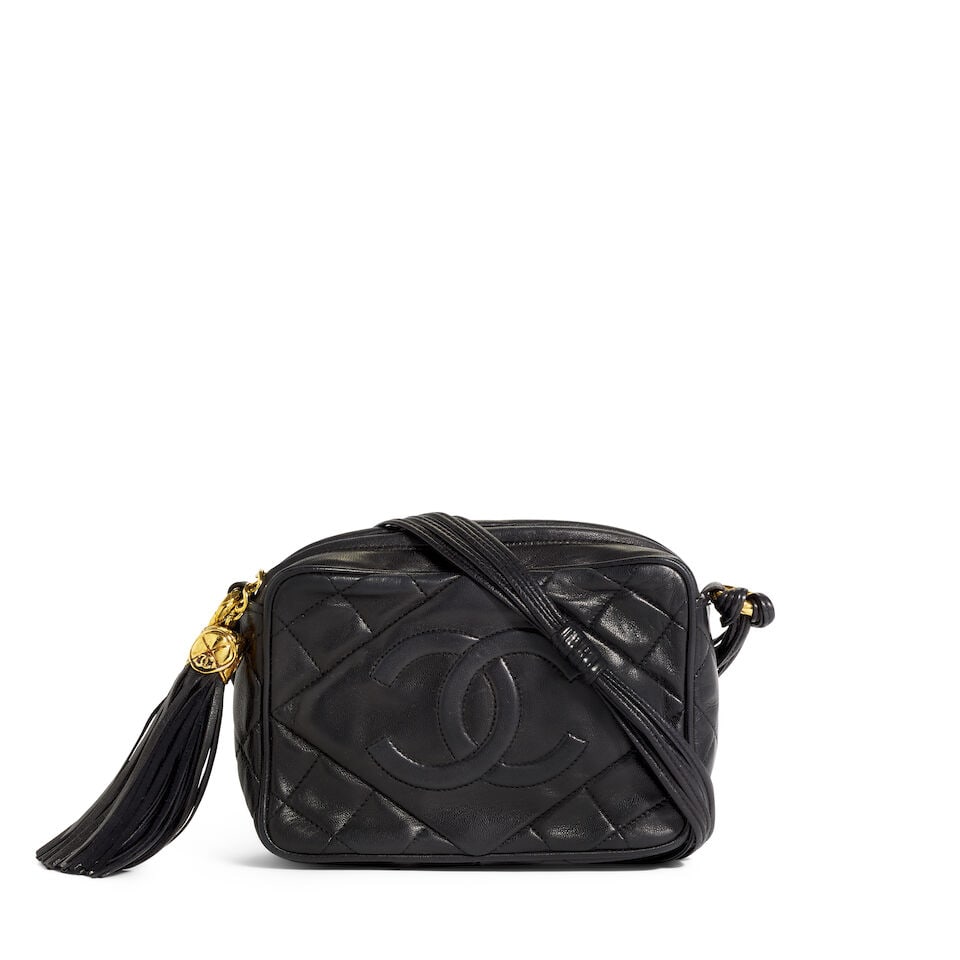 CHANEL: BLACK LEATHER TASSEL CAMERA BAG 1989-1991: CHANEL: BLACK LEATHER TASSEL CAMERA BAG 1989-1991 • Black Quilted Lambskin Leather Exterior • Gold Tone Hardware • Leather Shoulder Strap • CC Tassel Zip Closure • Leathe