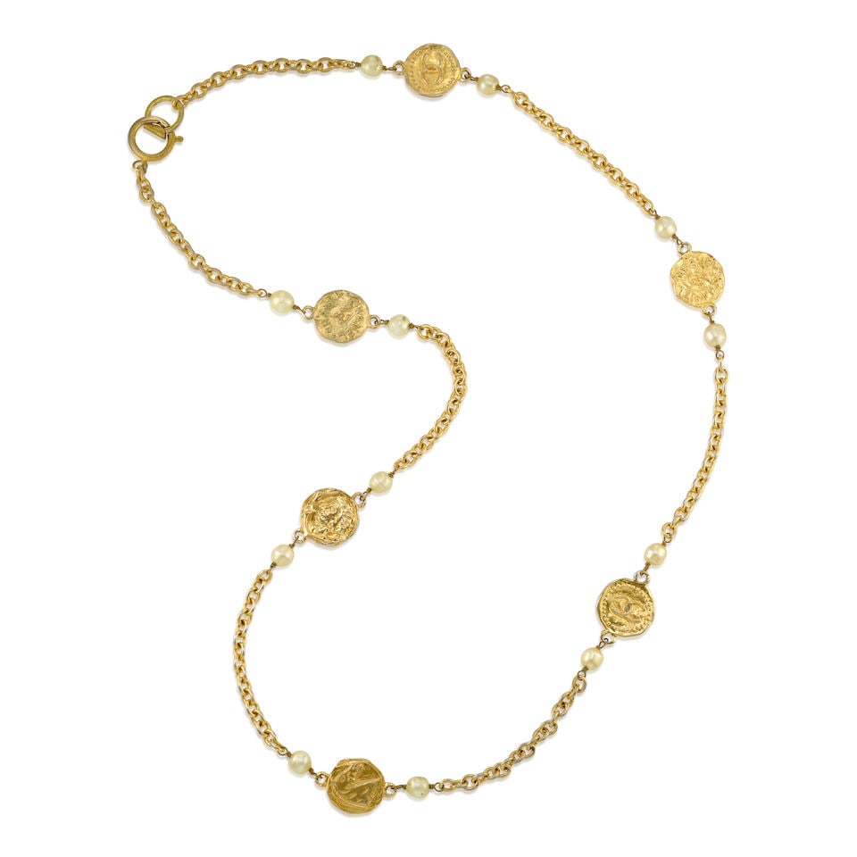 CHANEL: GOLD COIN AND PEARL NECKLACE 1970-1980: CHANEL: GOLD COIN AND PEARL NECKLACE 1970-1980 • Gold Tone Chain with Station Hammered Coins and Simulated Pearls • Spring Closure • Measures 45 cm Drop For further information on th