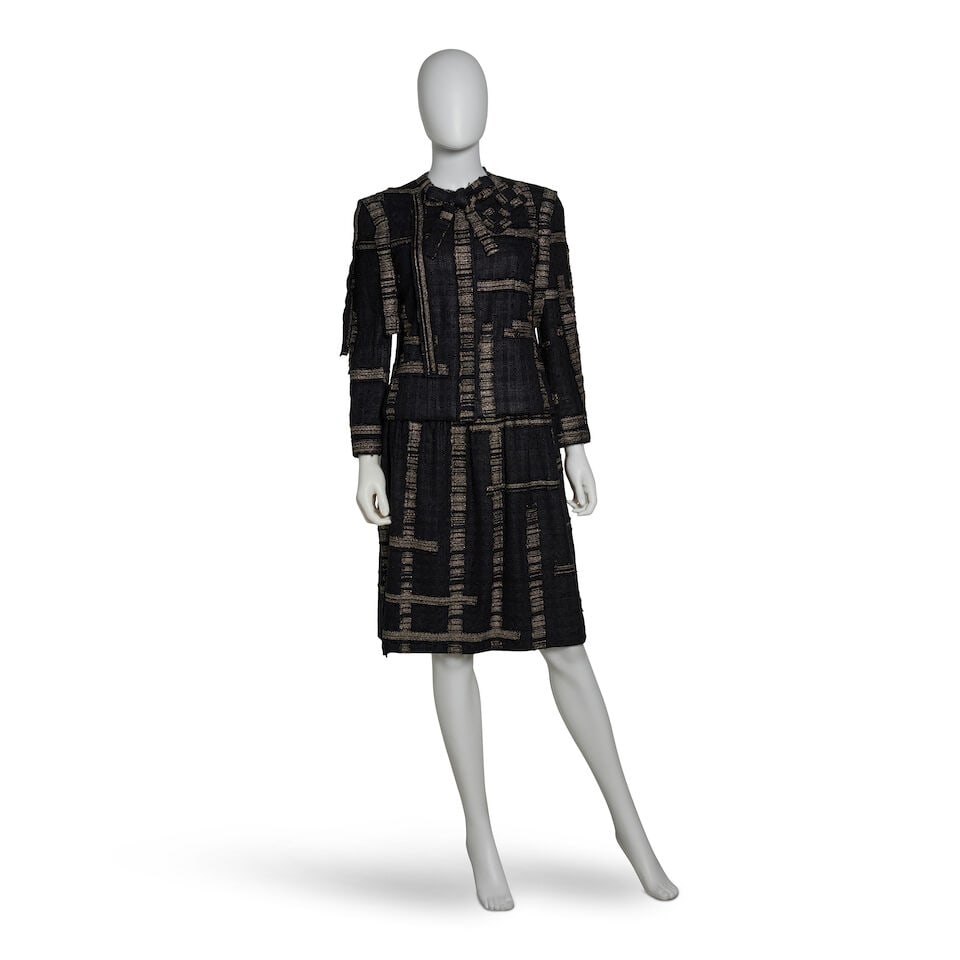 CHANEL: BLACK AND GOLD TWEED RIBBON SKIRT SUIT ENSEMBLE Fall 2006: CHANEL: BLACK AND GOLD TWEED RIBBON SKIRT SUIT ENSEMBLE Fall 2006 • Black Tweed with Gold Lurex Exterior • Ribbon Detailing Throughout Jacket • Two Matching Square Pins • Jacke