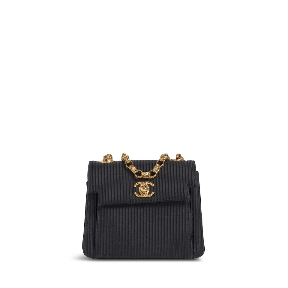 CHANEL: BLACK PLISSE MINI FLAP BAG Fall 1993: CHANEL: BLACK PLISSE MINI FLAP BAG Fall 1993 • Black Plisse Satin Exterior • Gold Tone Hardware • Bijoux Chain Shoulder Strap • Exterior and Interior Patch Pockets • Engr