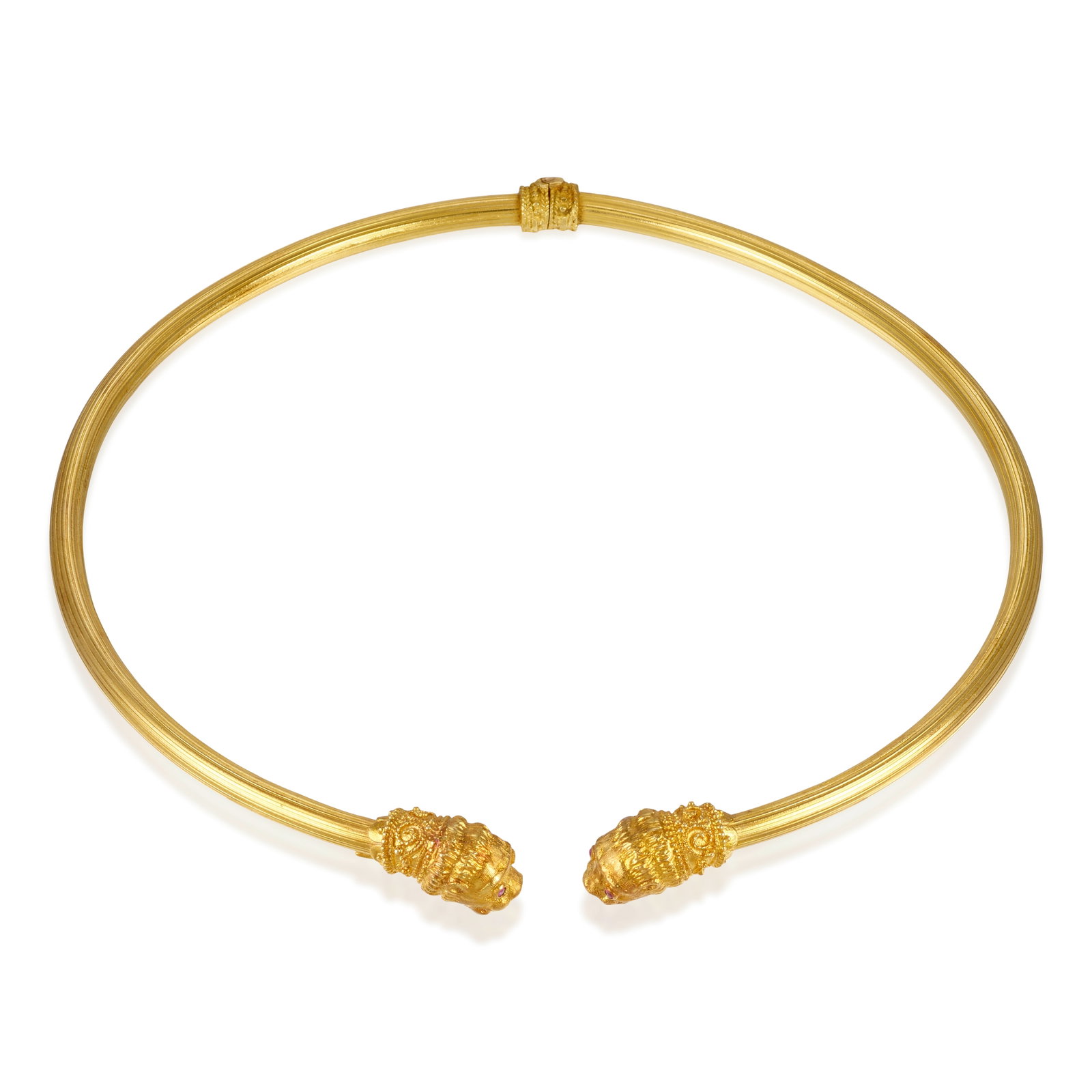 AN 18K GOLD AND RUBY NECKLACE: AN 18K GOLD AND RUBY NECKLACE A hinged collar with lions' head terminals, accented with round ruby eyes; with partial maker's mark; inner circumference 15 in., gap 1/4 in. Footnotes: OVERALL CONDITION