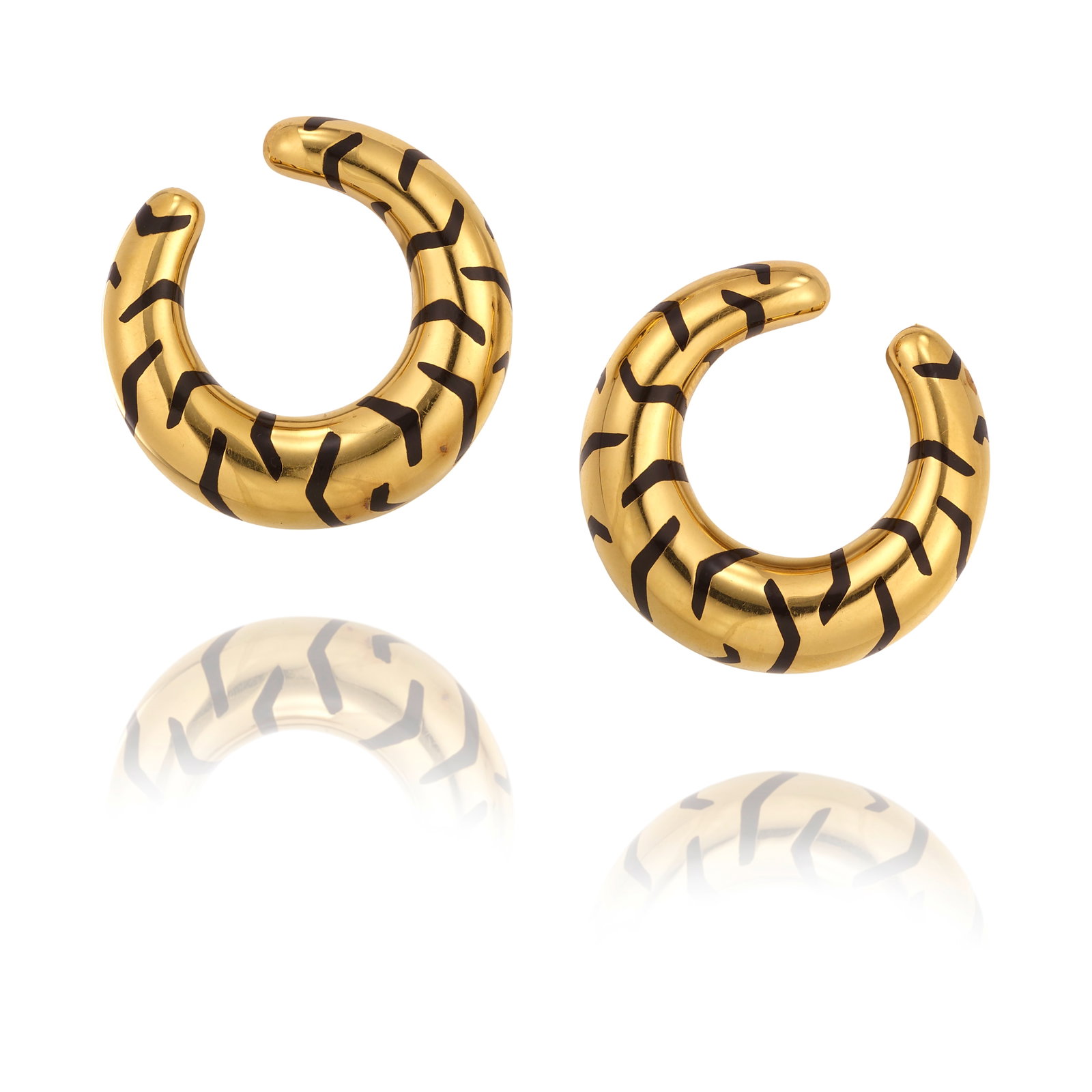 CARTIER: A PAIR OF 18K GOLD AND ENAMEL EARCLIPS, CIRCA 1990: CARTIER: A PAIR OF 18K GOLD AND ENAMEL EARCLIPS, CIRCA 1990 Accented with black enamel, tiger-inspired stripes; signed Cartier; with maker's mark; with French assay marks; with Italian registered trad