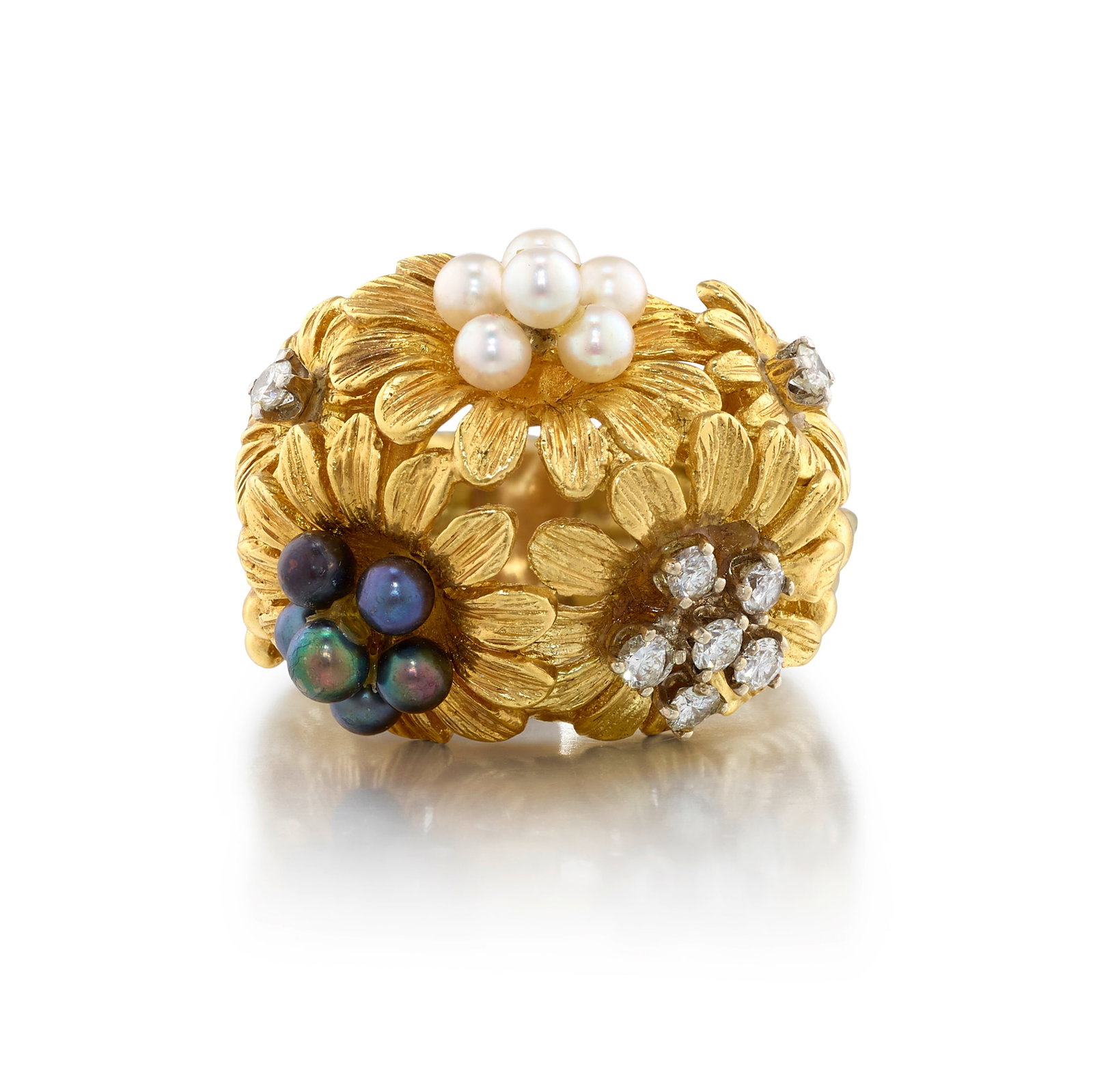 A CULTURED PEARL AND DIAMOND RING: A CULTURED PEARL AND DIAMOND RING Of bombé design, comprising a cluster of flowers, accented with round cultured pearls and round brilliant-cut diamonds; estimated total diamond weight 0.35