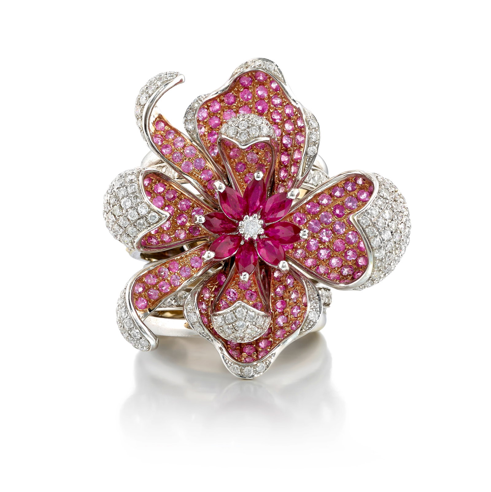 A DIAMOND, RUBY AND PINK SAPPHIRE RING: A DIAMOND, RUBY AND PINK SAPPHIRE RING Designed as a flower, the petals and shank pavé-set with round brilliant-cut diamonds and round sapphires, the center of the flowerhead accented with marqui