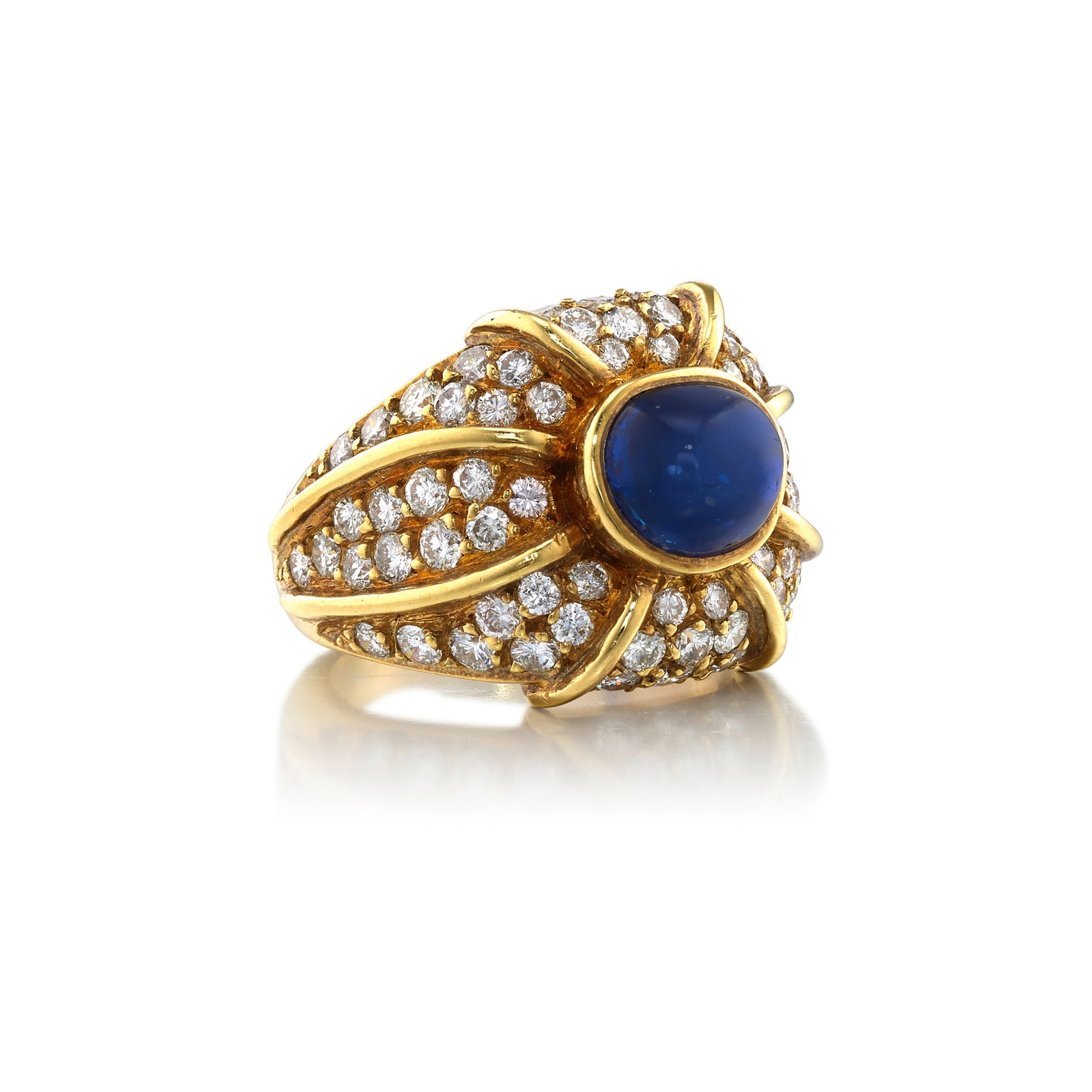 AN 18K GOLD, SAPPHIRE AND DIAMOND RING: AN 18K GOLD, SAPPHIRE AND DIAMOND RING Centering a free-form cabochon sapphire, in a mounting accented with pavé-set, round brilliant-cut diamonds; with maker's mark; estimated sapphire weight 4.