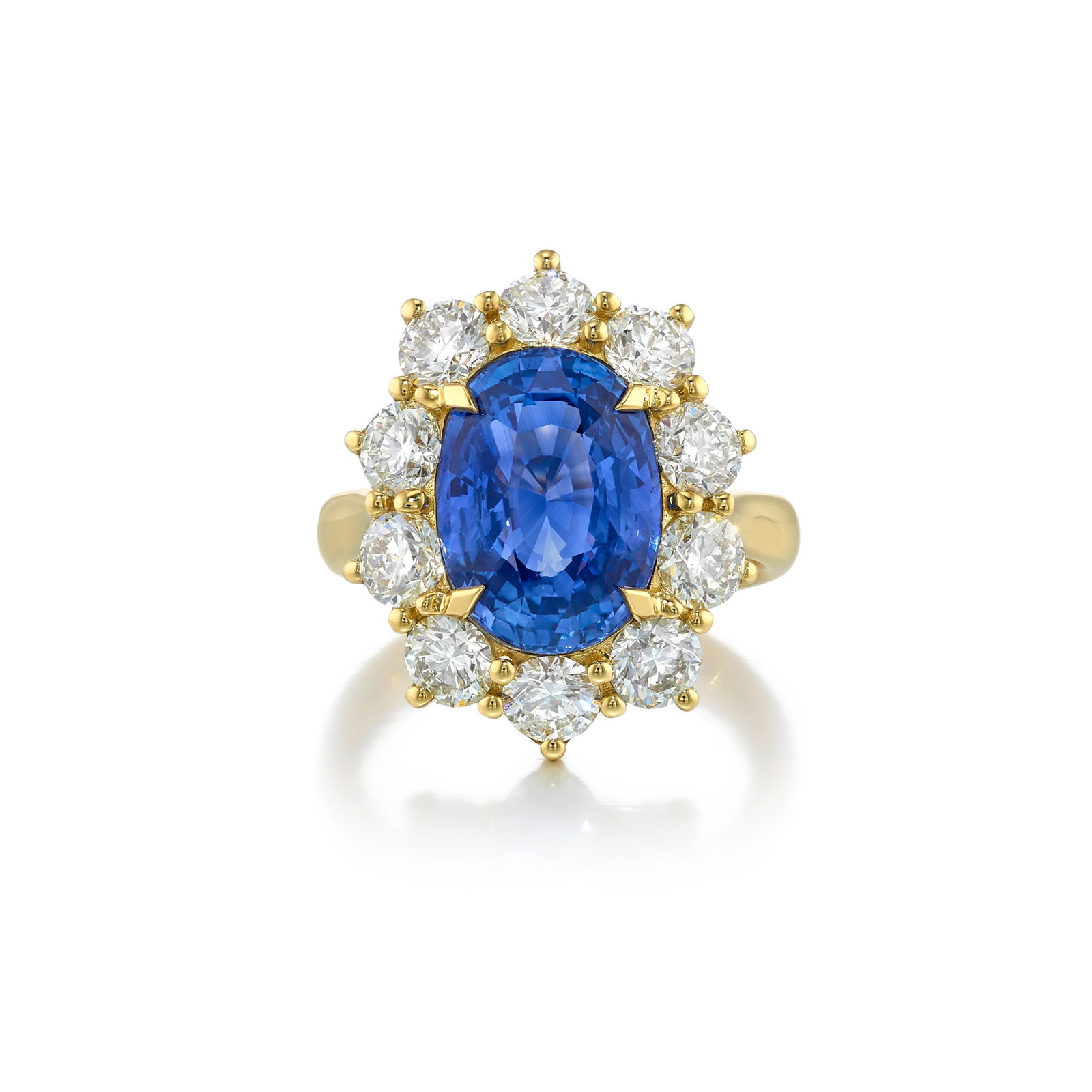AN 18K GOLD, SAPPHIRE AND DIAMOND RING: AN 18K GOLD, SAPPHIRE AND DIAMOND RING Centering an oval-shaped sapphire, in a surround of round brilliant-cut diamonds; estimated sapphire weight 7.25 carats; estimated total diamond weight 2.85 cara