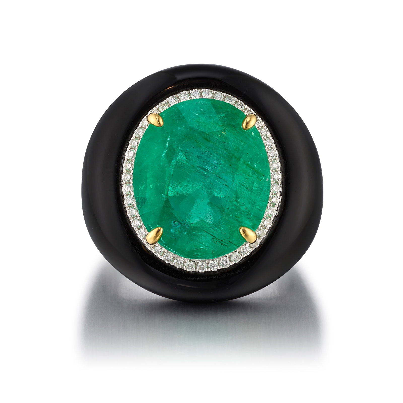 FEI LIU: A PLATINUM, EMERALD, ONYX AND DIAMOND RING: FEI LIU: A PLATINUM, EMERALD, ONYX AND DIAMOND RING Centering an oval-shaped emerald in a surround of round brilliant-cut diamonds, mounted in carved onyx; with maker's mark; with English hallmarks,