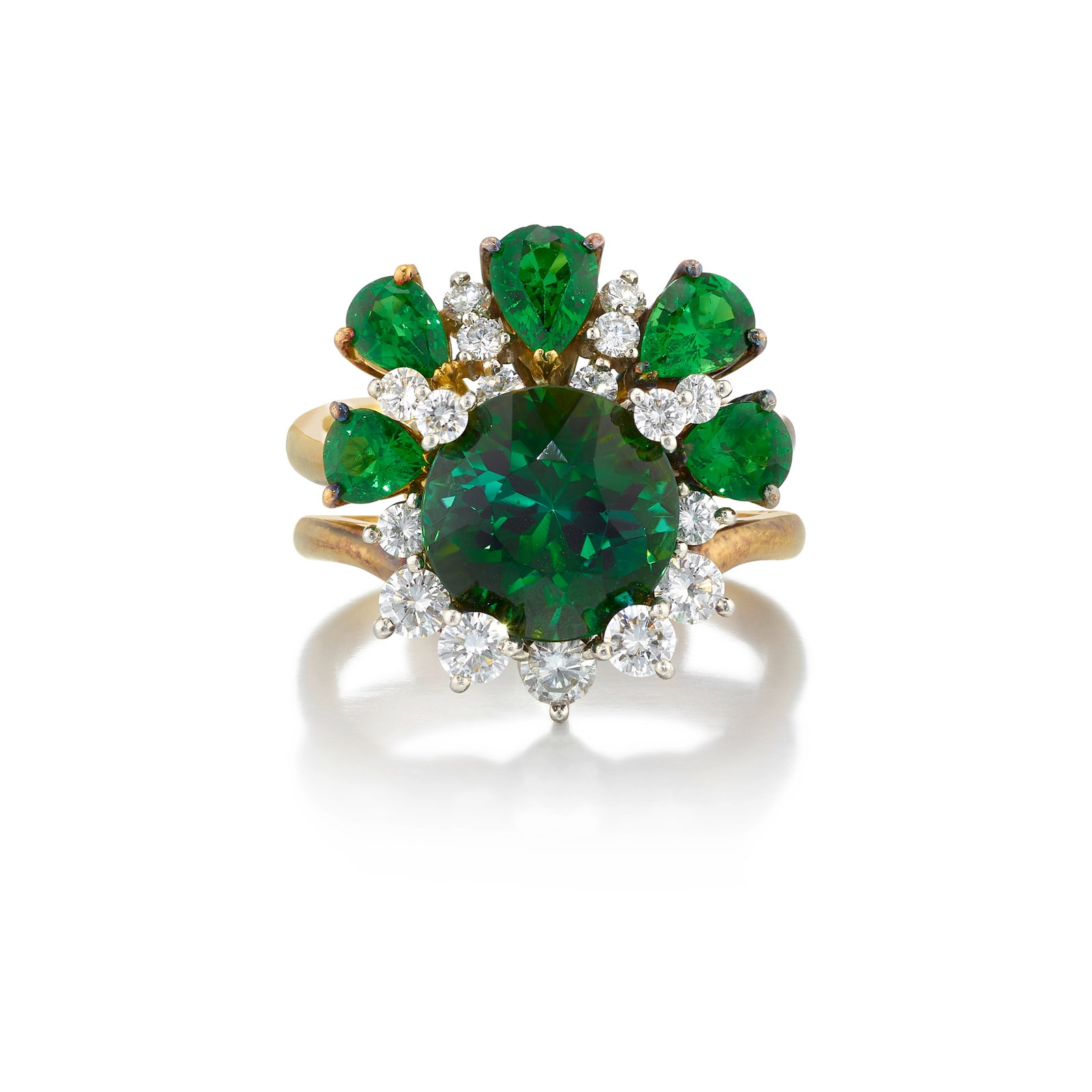 AN 18K GOLD, PLATINUM, TOURMALINE, GARNET AND DIAMOND RING: AN 18K GOLD, PLATINUM, TOURMALINE, GARNET AND DIAMOND RING Comprising a round tourmaline in a dimensional surround of round brilliant-cut diamonds, accented by pear-shaped tsavorite garnets; with make