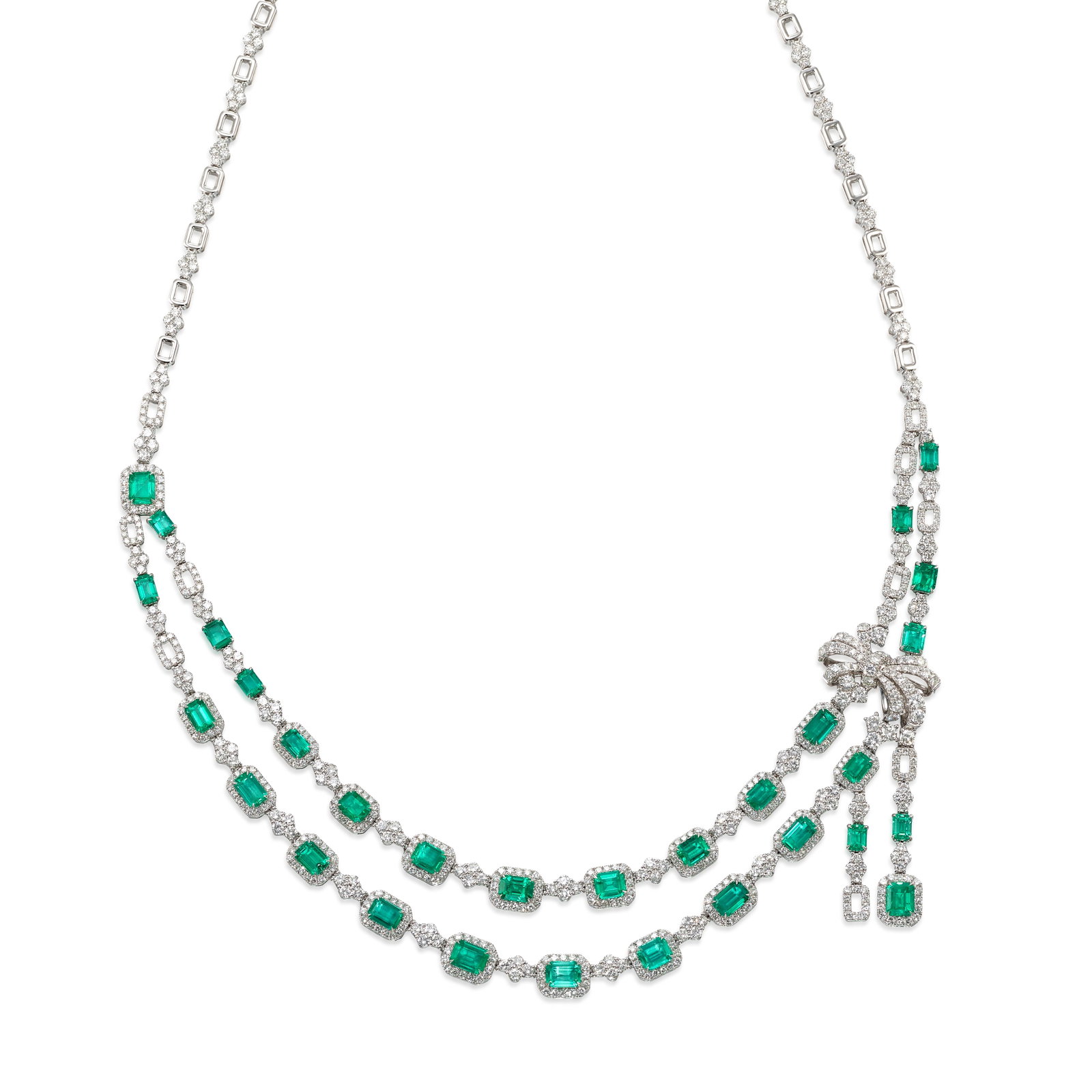 AN EMERALD AND DIAMOND NECKLACE: AN EMERALD AND DIAMOND NECKLACE Composed of two rows of octagonal step-cut emeralds, all framed and linked by clusters of round brilliant-cut diamonds, with bow and drop details, the backchain alterna