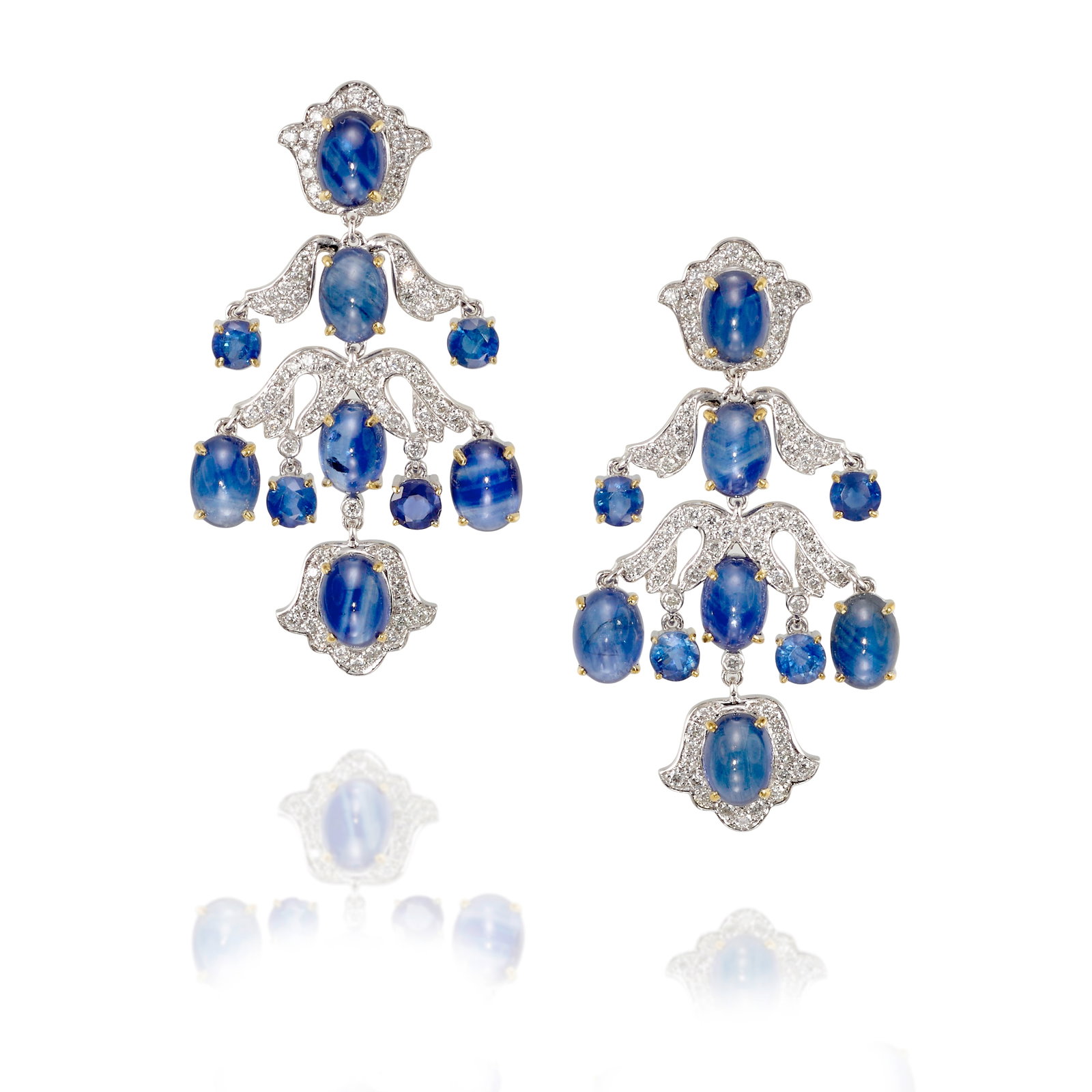 A PAIR OF PLATINUM, SAPPHIRE AND DIAMOND EARRINGS: A PAIR OF PLATINUM, SAPPHIRE AND DIAMOND EARRINGS Each composed of oval-shaped cabochon sapphires, accented with round sapphires and round brilliant-cut diamonds; estimated total sapphire weight 7.50