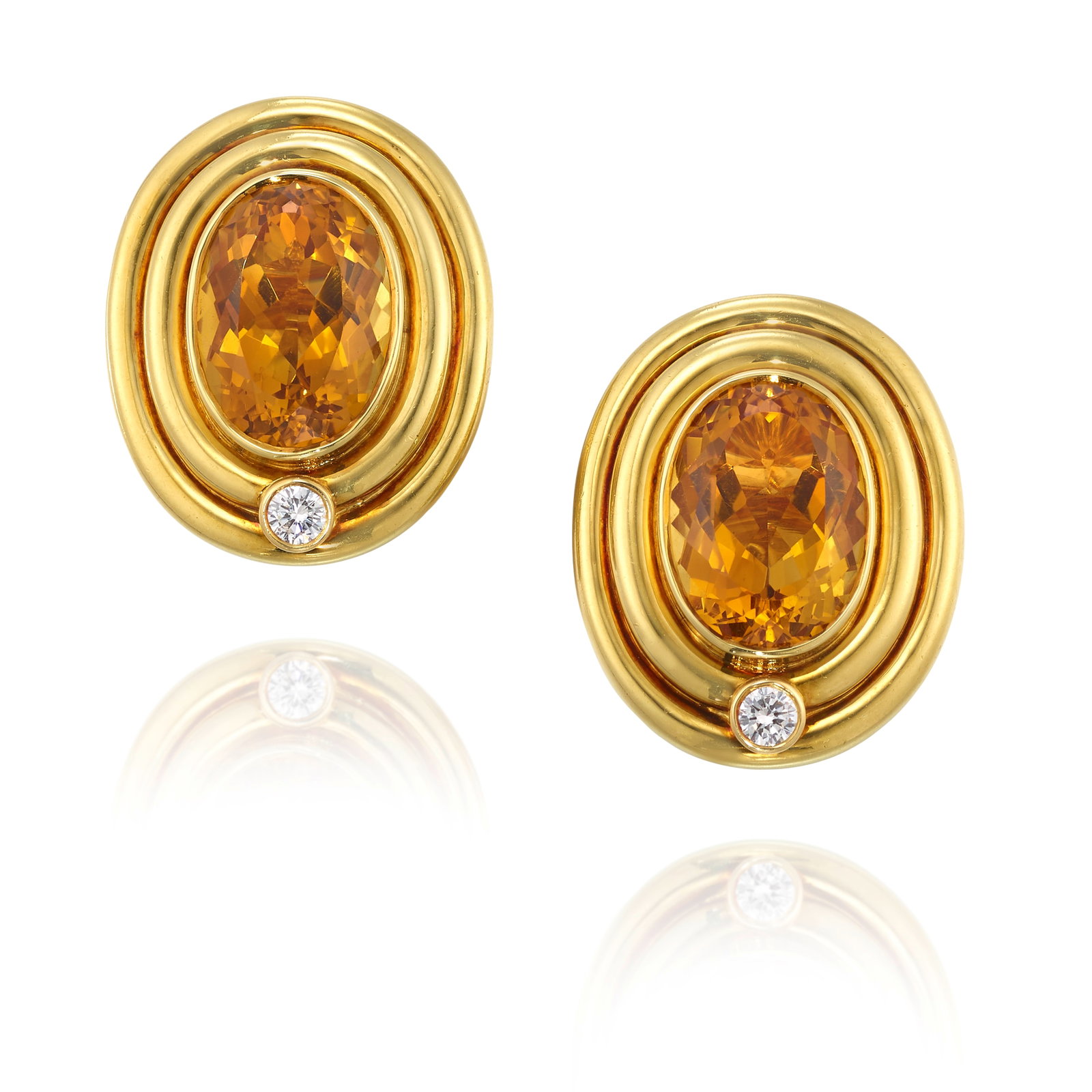 PIAGET: A PAIR OF CITRINE AND DIAMOND EARCLIPS: PIAGET: A PAIR OF CITRINE AND DIAMOND EARCLIPS Each centering oval-shaped citrines, accented by single round brilliant-cut diamonds; signed Piaget; with Swiss assay marks, Geneva; estimated total citr