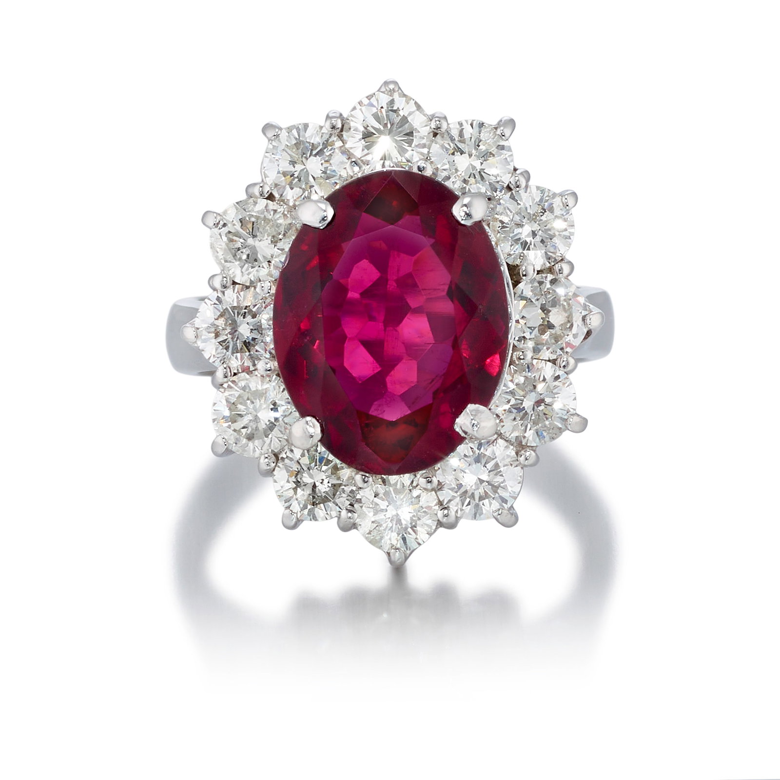 A 14K WHITE GOLD, RUBELLITE TOURMALINE AND DIAMOND RING: A 14K WHITE GOLD, RUBELLITE TOURMALINE AND DIAMOND RING Centering an oval-shaped rubellite tourmaline, in a surround of round brilliant-cut diamonds; estimated tourmaline weight 3.90 carats; estimated