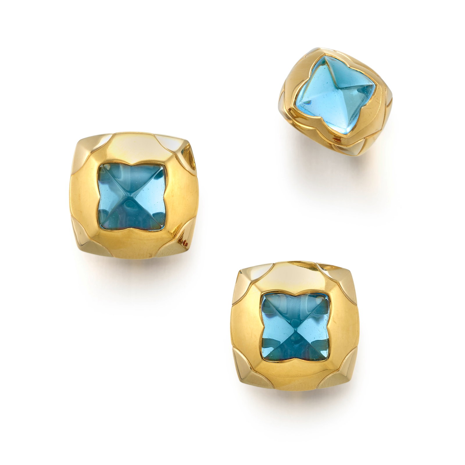 BULGARI: AN 18K BICOLOR GOLD AND BLUE TOPAZ 'PYRAMID' RING AND EARCLIP SET: BULGARI: AN 18K BICOLOR GOLD AND BLUE TOPAZ 'PYRAMID' RING AND EARCLIP SET All of high polish gold design, centering carved pyramidal blue topaz; all signed Bulgari; with maker's marks; with Italian r