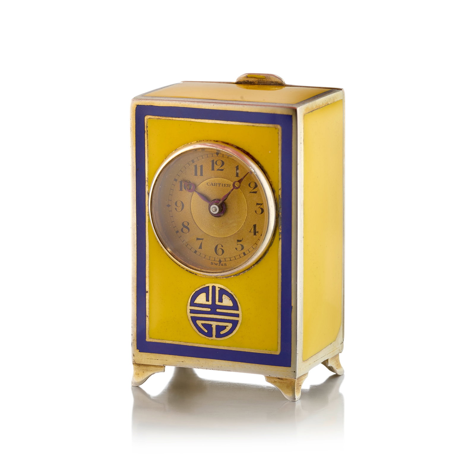 CARTIER: AN ENAMEL DESK CLOCK, CIRCA 1920: CARTIER: AN ENAMEL DESK CLOCK, CIRCA 1920 Designed with winding movement, the round dial signed Cartier with Arabic numeral hour markers, the case of yellow and blue enamelwork; dial signed Cartier; i