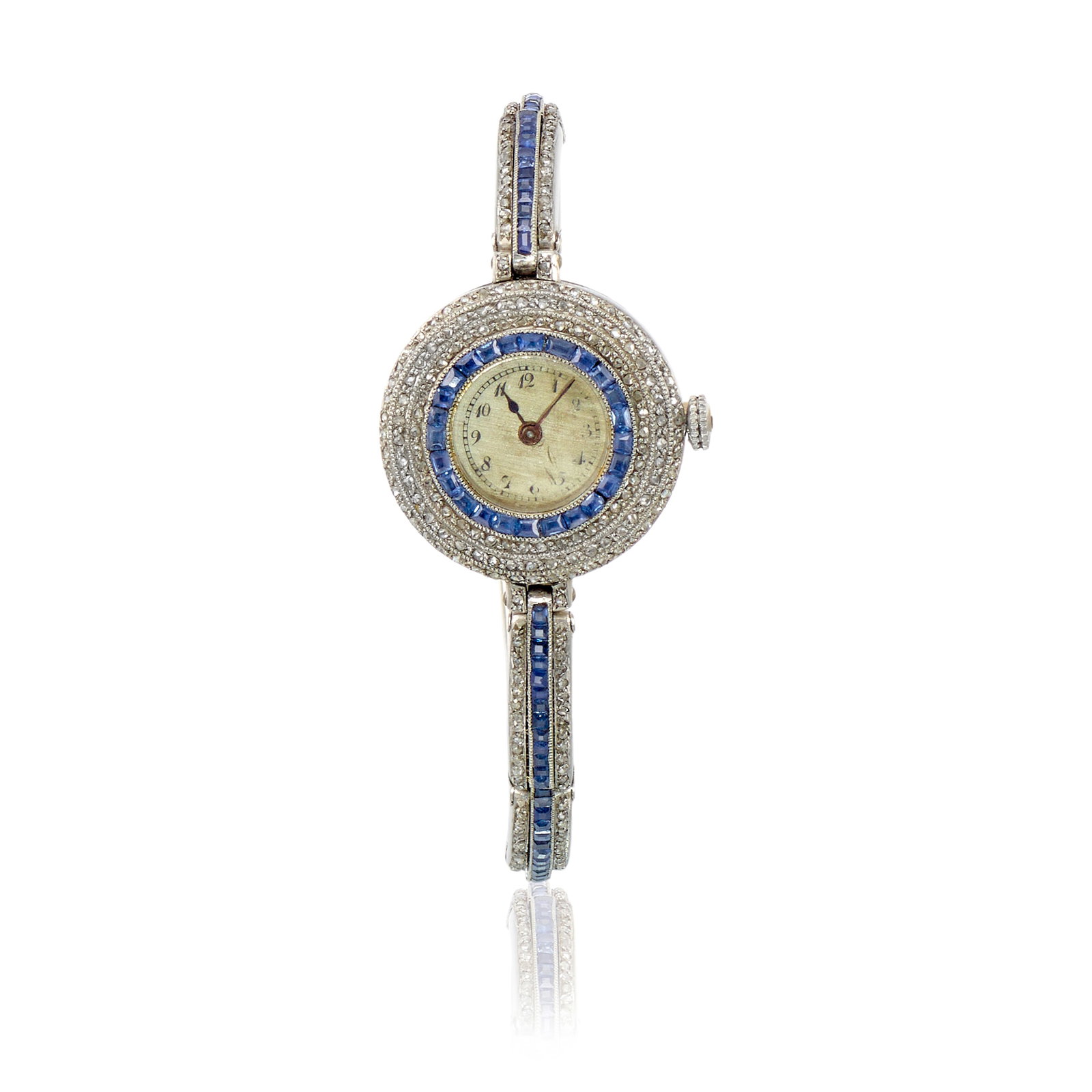 A PLATINUM, SAPPHIRE AND DIAMOND WRISTWATCH, FRANCE, CIRCA 1915: A PLATINUM, SAPPHIRE AND DIAMOND WRISTWATCH, FRANCE, CIRCA 1915 Designed with manual movement, the round dial unsigned and with Arabic numeral hour markers, the case and expandable bracelet accented