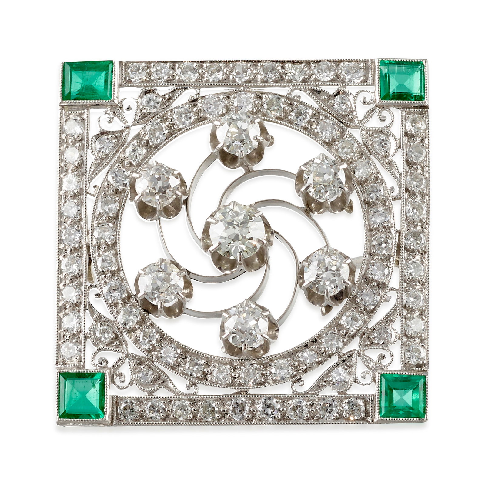 A DIAMOND AND EMERALD BROOCH, CIRCA 1925: A DIAMOND AND EMERALD BROOCH, CIRCA 1925 Of openwork design, centering a whorl of old European-cut diamonds, surrounded and framed by old European and transitional-cut diamonds, each corner accented