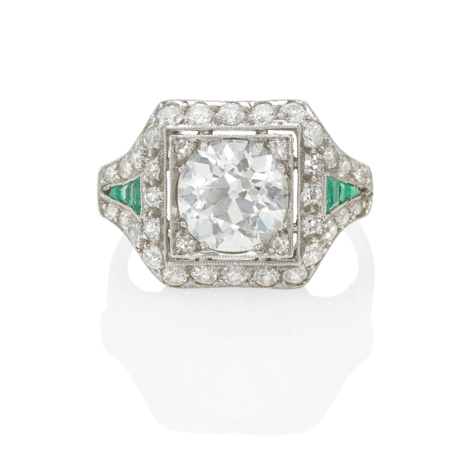 A PLATINUM, DIAMOND AND EMERALD RING, CIRCA 1925: A PLATINUM, DIAMOND AND EMERALD RING, CIRCA 1925 Centering an old European-cut diamond, surrounded by old European and single-cut diamonds, further accented with calibré-cut emeralds, the shank