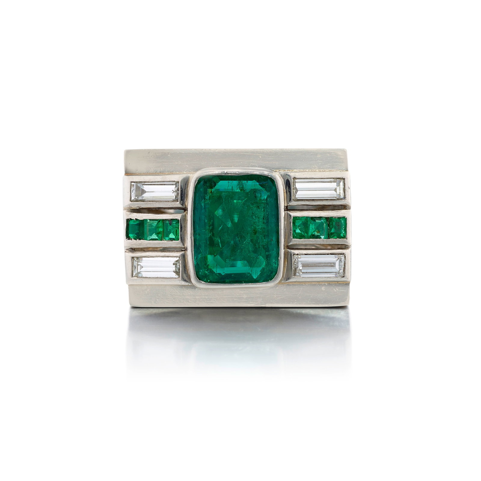 A PLATINUM, EMERALD AND DIAMOND RING, FRANCE, CIRCA 1935: A PLATINUM, EMERALD AND DIAMOND RING, FRANCE, CIRCA 1935 Centering an octagonal mixed-cut emerald, flanked by bands of square step-cut emeralds and baguette-cut diamonds; with maker's mark; with