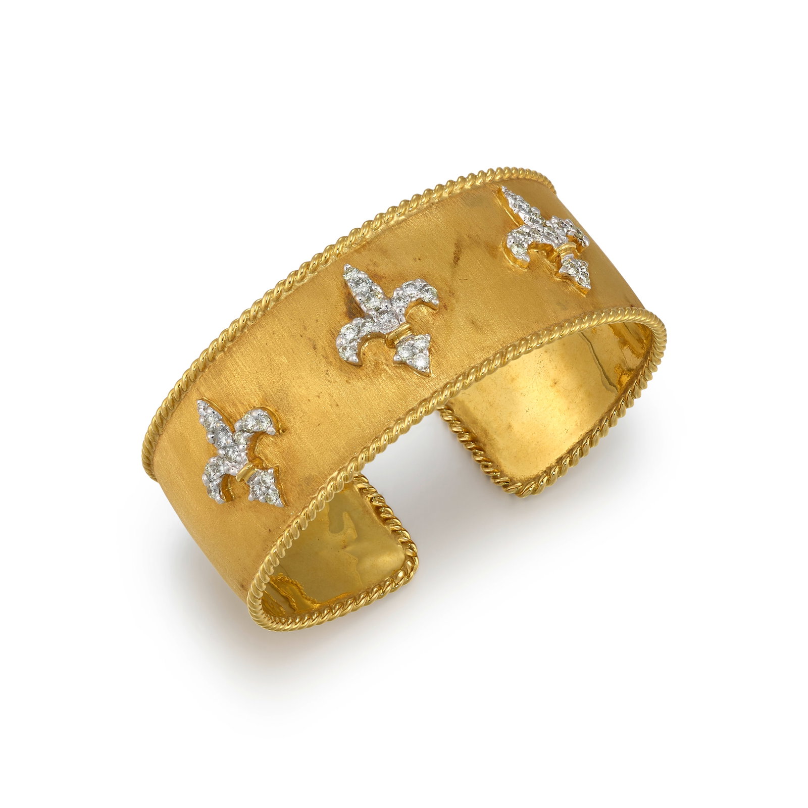 AN 18K GOLD AND DIAMOND BRACELET: AN 18K GOLD AND DIAMOND BRACELET A flexible cuff bracelet of textured gold, centering three fleur-de-lis accented with round brilliant-cut diamonds; estimated total diamond weight 1.35 carats; inner