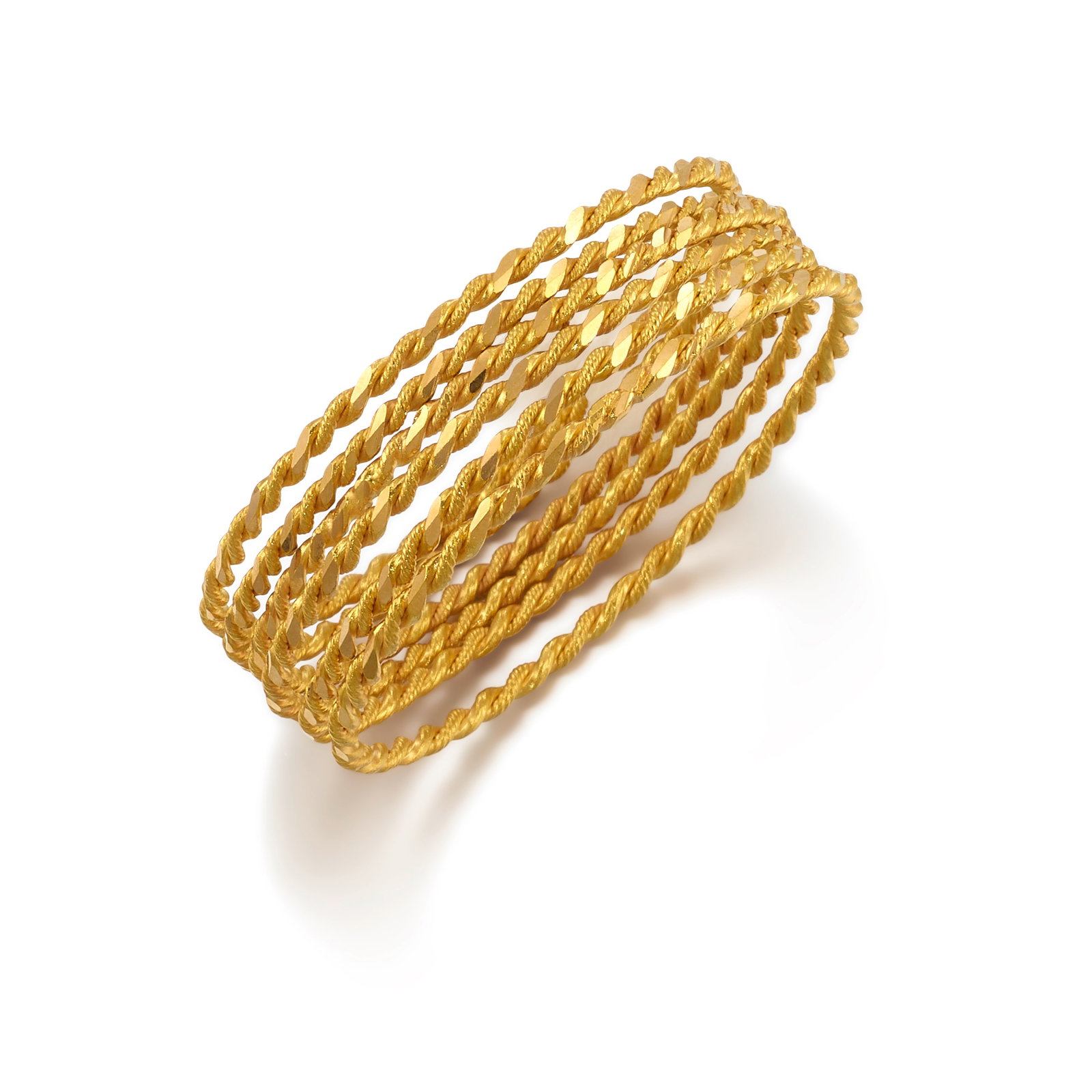 A SET OF GOLD BANGLES: A SET OF GOLD BANGLES Each of twisted rope design; fabricated in 22k gold; inner circumference 7 1/4 in. Footnotes: OVERALL CONDITION: Metal purity unstamped and tested with XRF (X-ray fluorescence) f