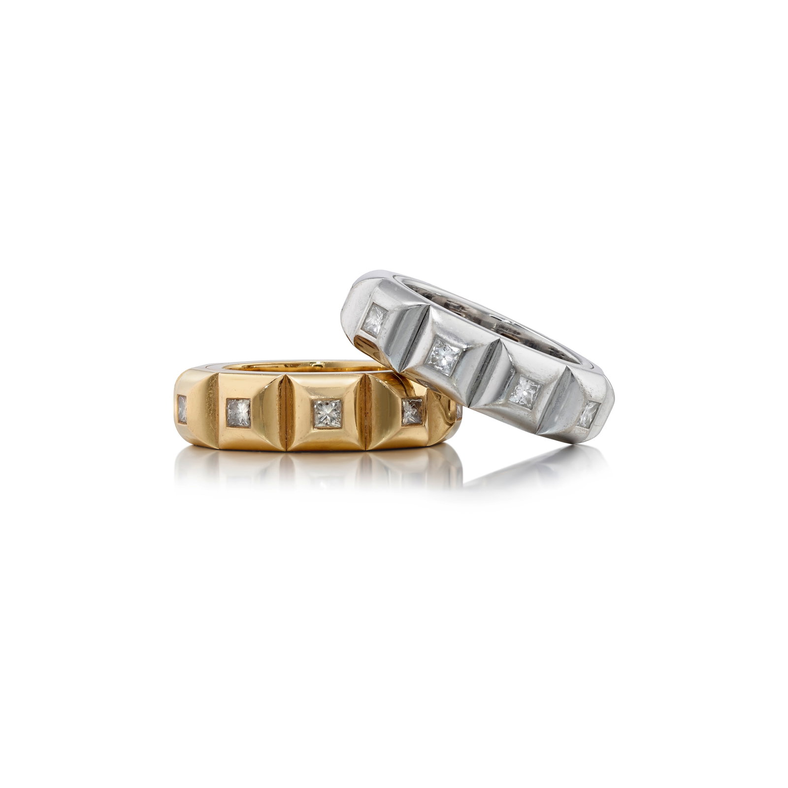 HANS D. KRIEGER: A SET OF 18K GOLD AND DIAMOND RINGS: HANS D. KRIEGER: A SET OF 18K GOLD AND DIAMOND RINGS Each band comprising pyramidal studs, accented with square, mixed-cut diamonds; both with maker's marks; each band estimated total diamond weight