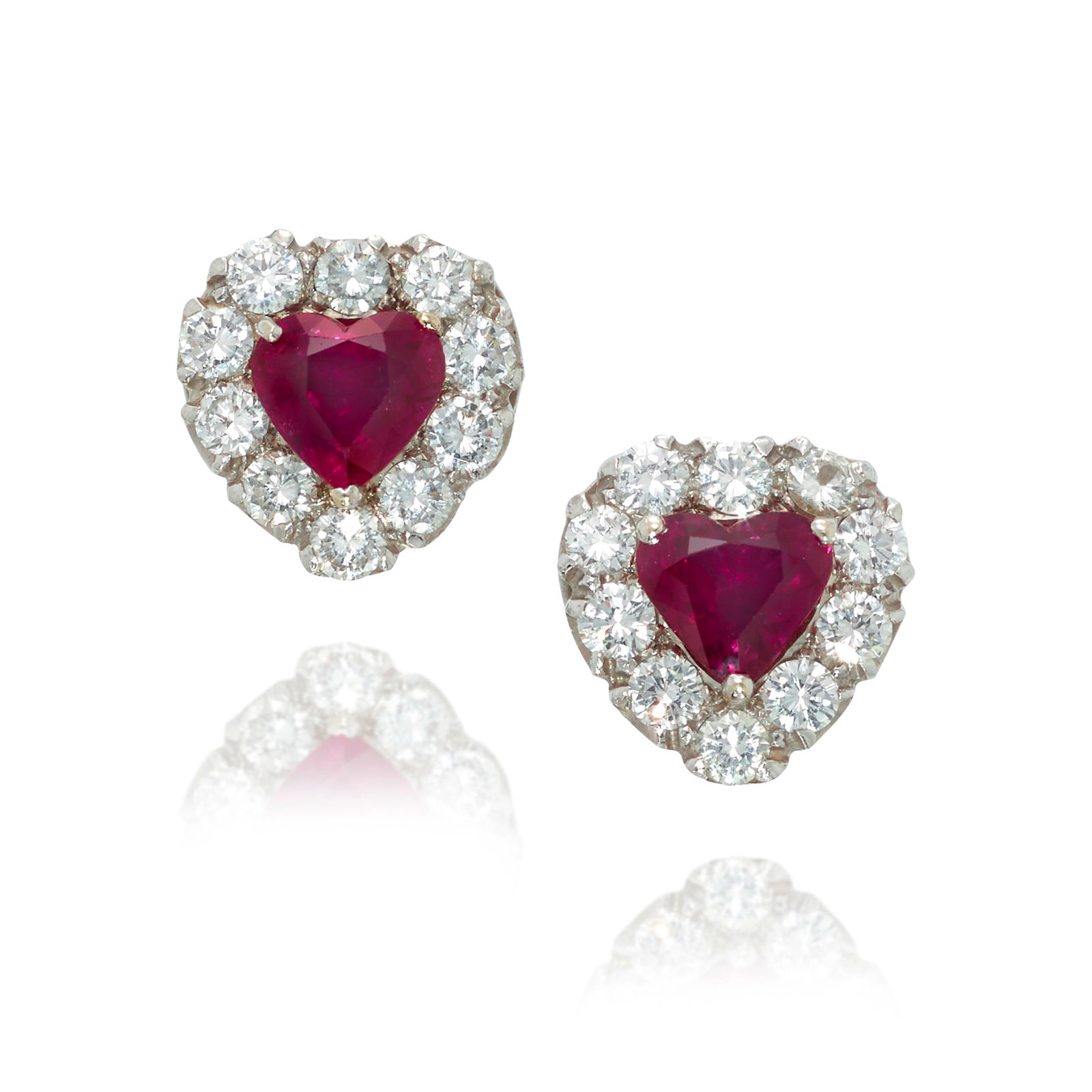 A PAIR OF RUBY AND DIAMOND EARRINGS: A PAIR OF RUBY AND DIAMOND EARRINGS Each centering a heart-shaped ruby, in a surround of round brilliant-cut diamonds; estimated ruby weights 2.00 carats each; estimated total diamond weight 1.80