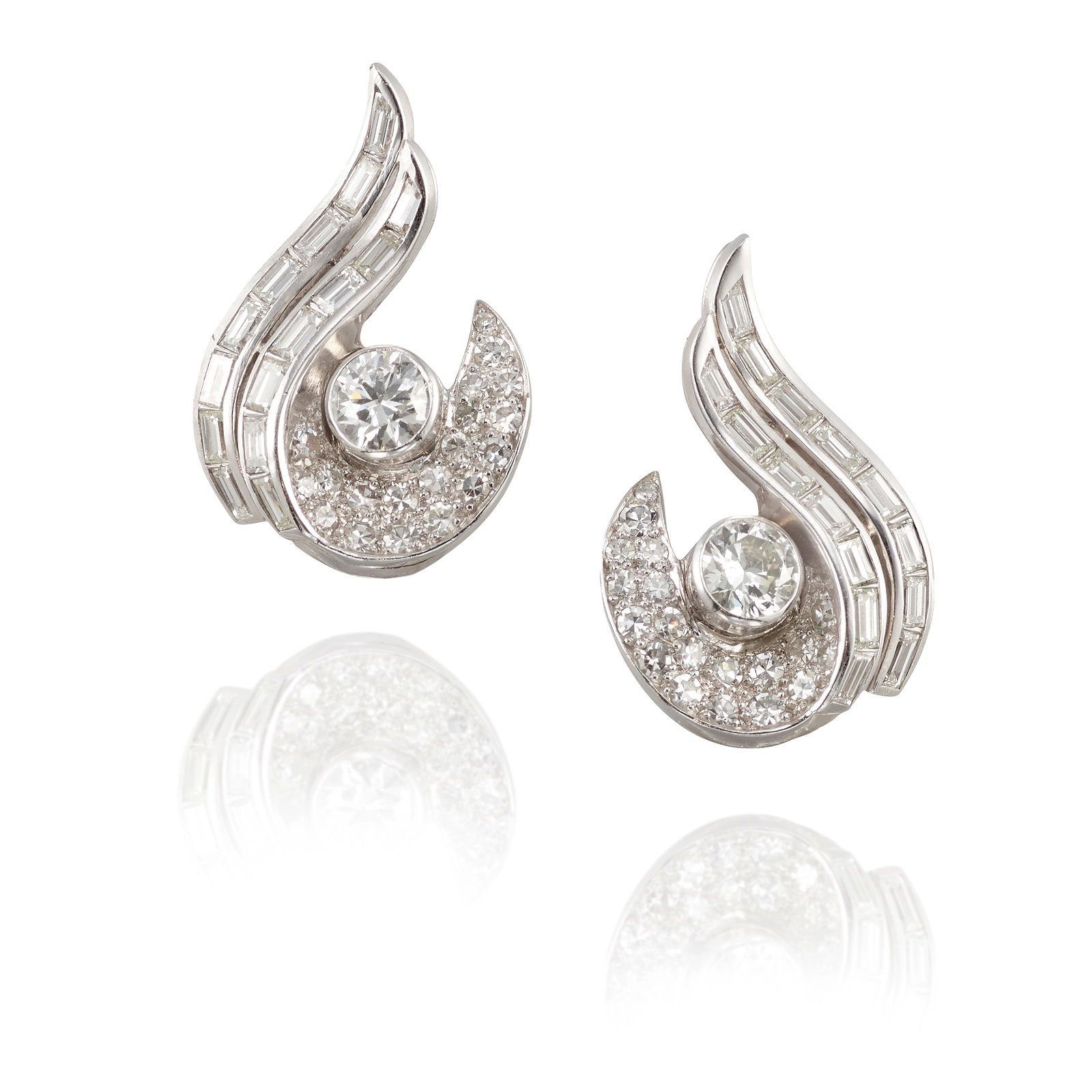A PAIR OF DIAMOND EARCLIPS, CIRCA 1950: A PAIR OF DIAMOND EARCLIPS, CIRCA 1950 Centering round brilliant-cut diamonds, accented by ribbons of baguette-cut diamonds and pavé-set single-cut diamonds; estimated round brilliant-cut