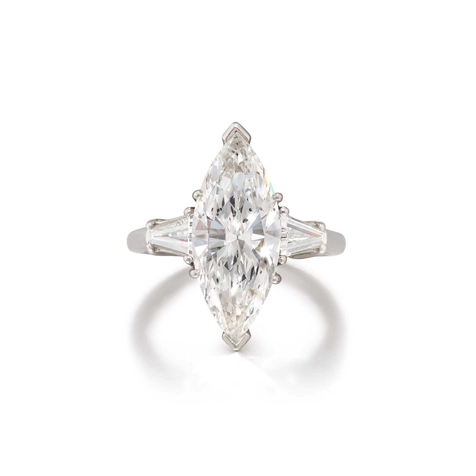 A PLATINUM AND DIAMOND RING: A PLATINUM AND DIAMOND RING Centering a marquise-shaped diamond, flanked by tapered-baguette diamonds; estimated center diamond weight 3.75 carats; estimated total accent diamond weight 0.40 carat; si