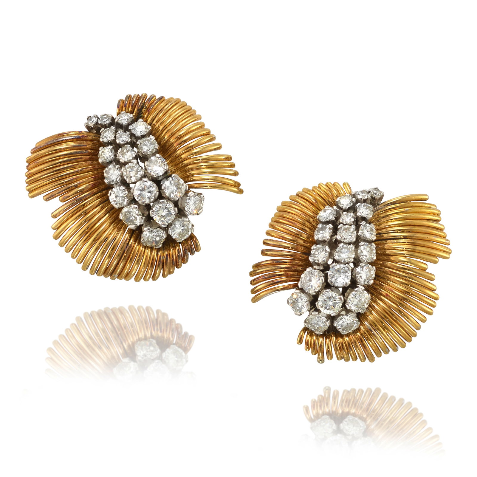 A PAIR OF DIAMOND EARCLIPS, CIRCA 1950: A PAIR OF DIAMOND EARCLIPS, CIRCA 1950 Each centering clusters of round brilliant and single-cut diamonds, framed by fronds of gold; estimated total diamond weight 3.00 carats; mounted in a palladium,