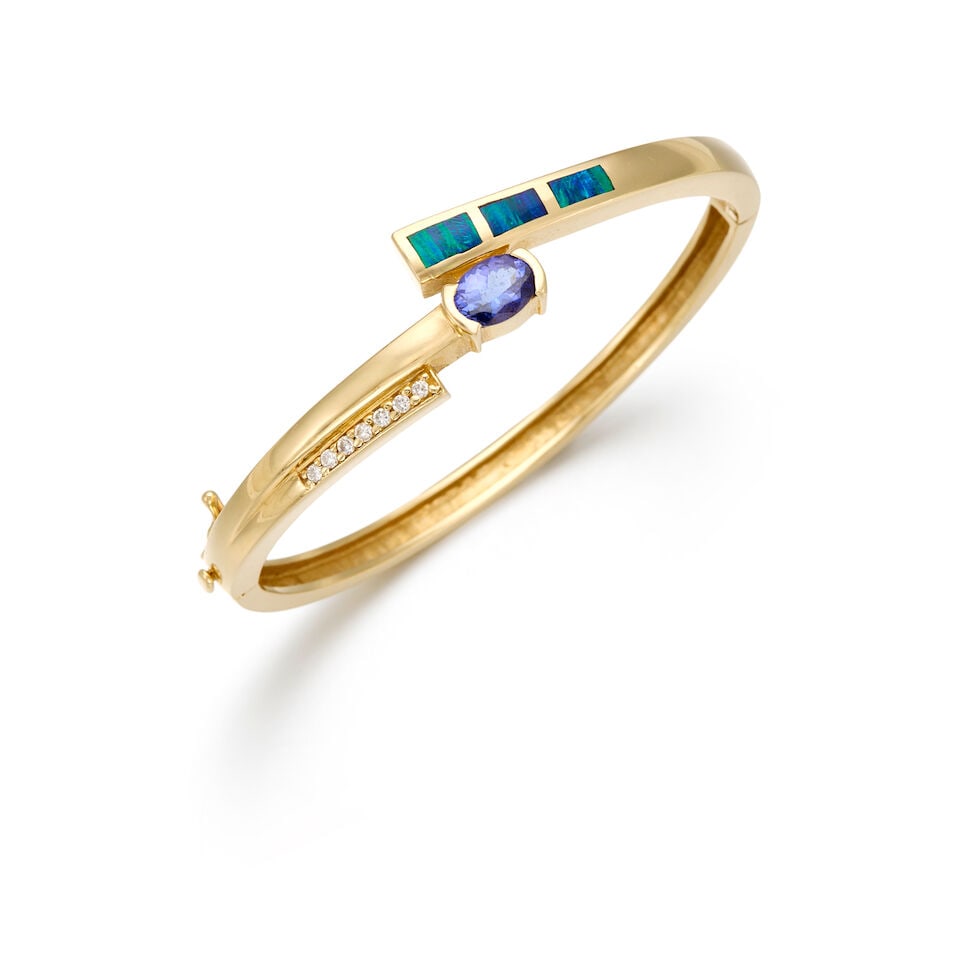 14K YELLOW GOLD, TANZANITE, OPAL AND DIAMOND BANGLE BRACELET: 14K YELLOW GOLD, TANZANITE, OPAL AND DIAMOND BANGLE BRACELET • One oval shaped tanzanite weighing approximately 1.67 carats total • Three rectangular shaped opal measuring approximately
