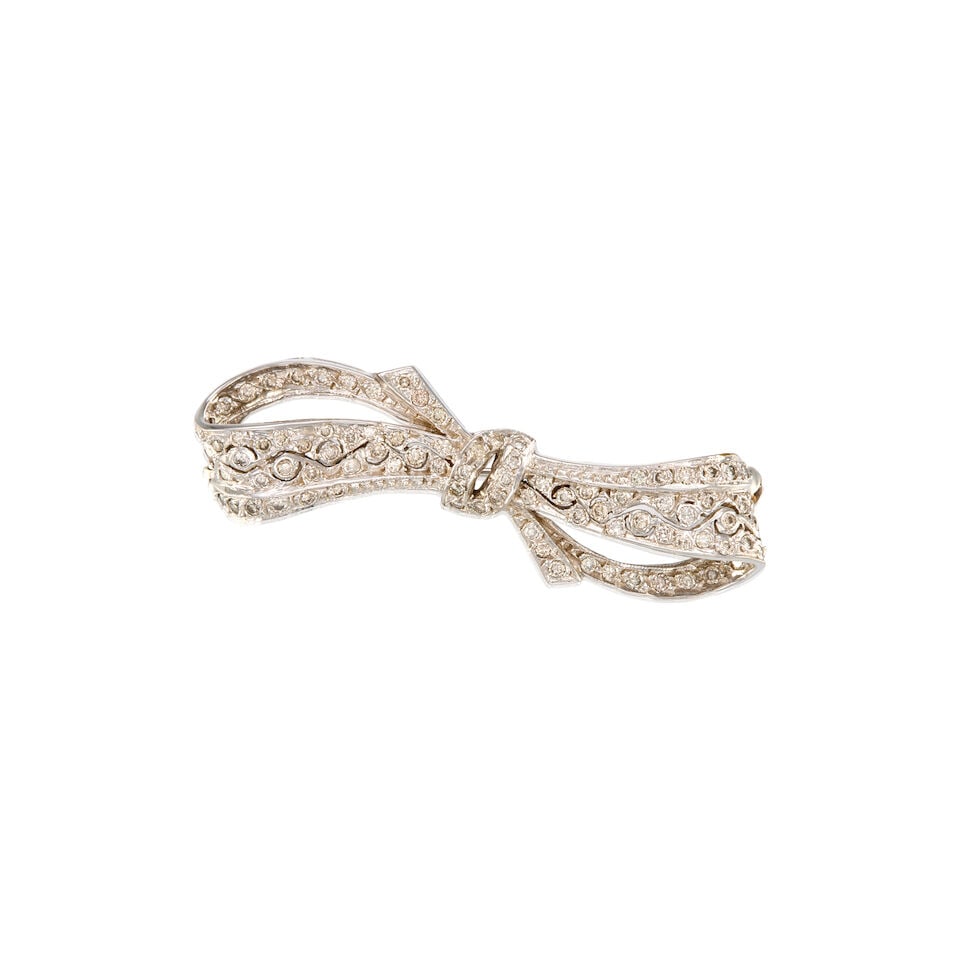 14K WHITE GOLD AND DIAMOND BOW BROOCH: 14K WHITE GOLD AND DIAMOND BOW BROOCH • Numerous round brilliant cut diamonds measuring approximately 1mm to 1.5mm in diameter • Measures 2 in. x 1/4 in. • Estimated gross weight: