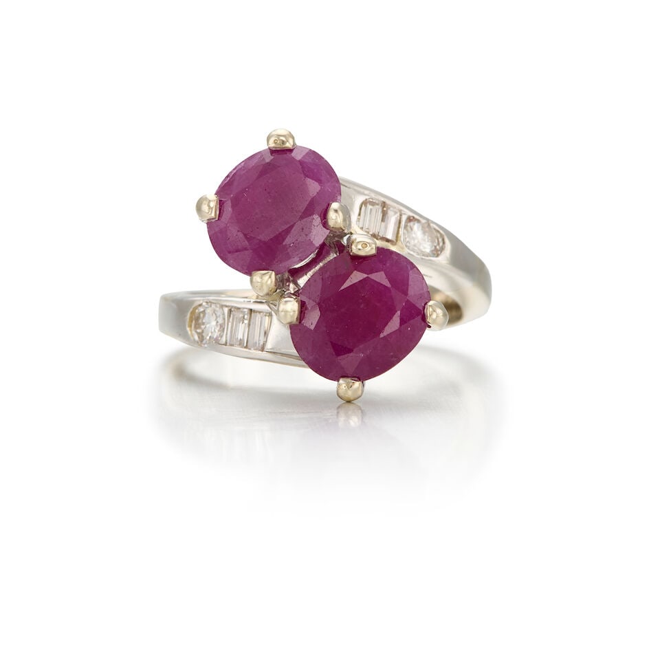 14K WHITE GOLD, RUBY AND DIAMOND RING: 14K WHITE GOLD, RUBY AND DIAMOND RING • Two oval shaped rubies weighing approximately 2.60 carats total • Two round brilliant cut diamonds weighing approximately 0.20 carat total and four 