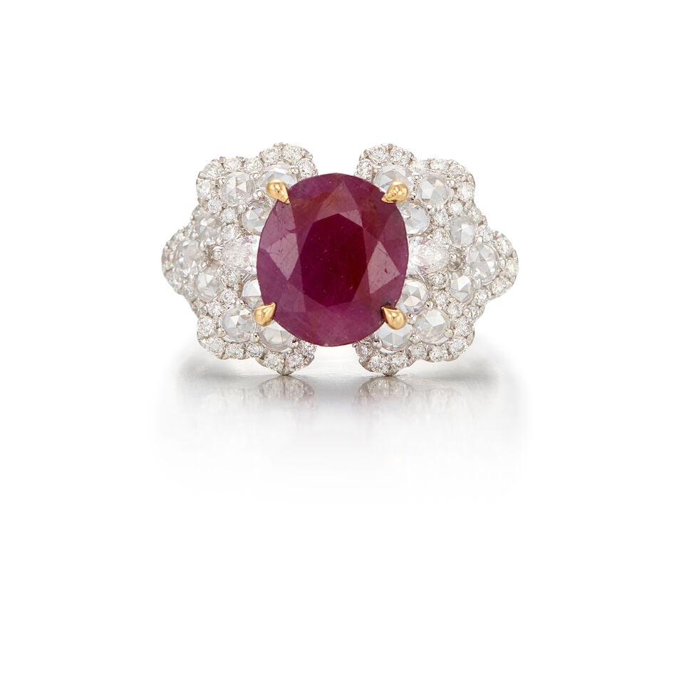 18K WHITE GOLD, RUBY AND DIAMOND RING: 18K WHITE GOLD, RUBY AND DIAMOND RING • One oval shaped ruby weighing approximately 2.20 carats total • Two pear brilliant cut diamonds weighing approximately 0.12 carat total, numerous