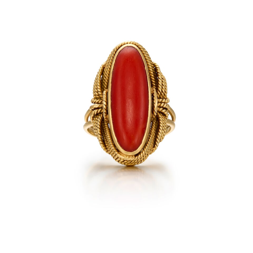 18K YELLOW GOLD AND CORAL RING: 18K YELLOW GOLD AND CORAL RING • One oval shaped coral measuring approximately 23.93mm x 8.17mm x 3.52mm • Size 7 3/4 • Estimated gross weight: 9.8 grams Footnotes: Please note this