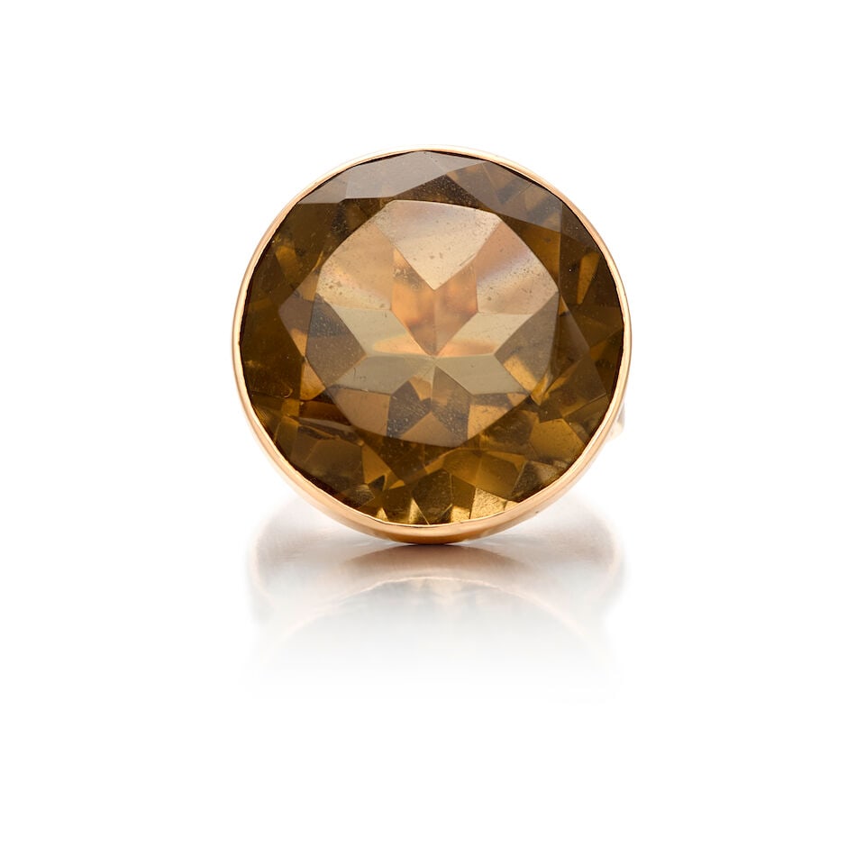 13K YELLOW GOLD AND TOPAZ RING: 13K YELLOW GOLD AND TOPAZ RING • A round shaped topaz weighing approximately 25 carats • Size 8 1/4 • Estimated gross weight: 9.2 grams Footnotes: OVERALL CONDITION: good Metal