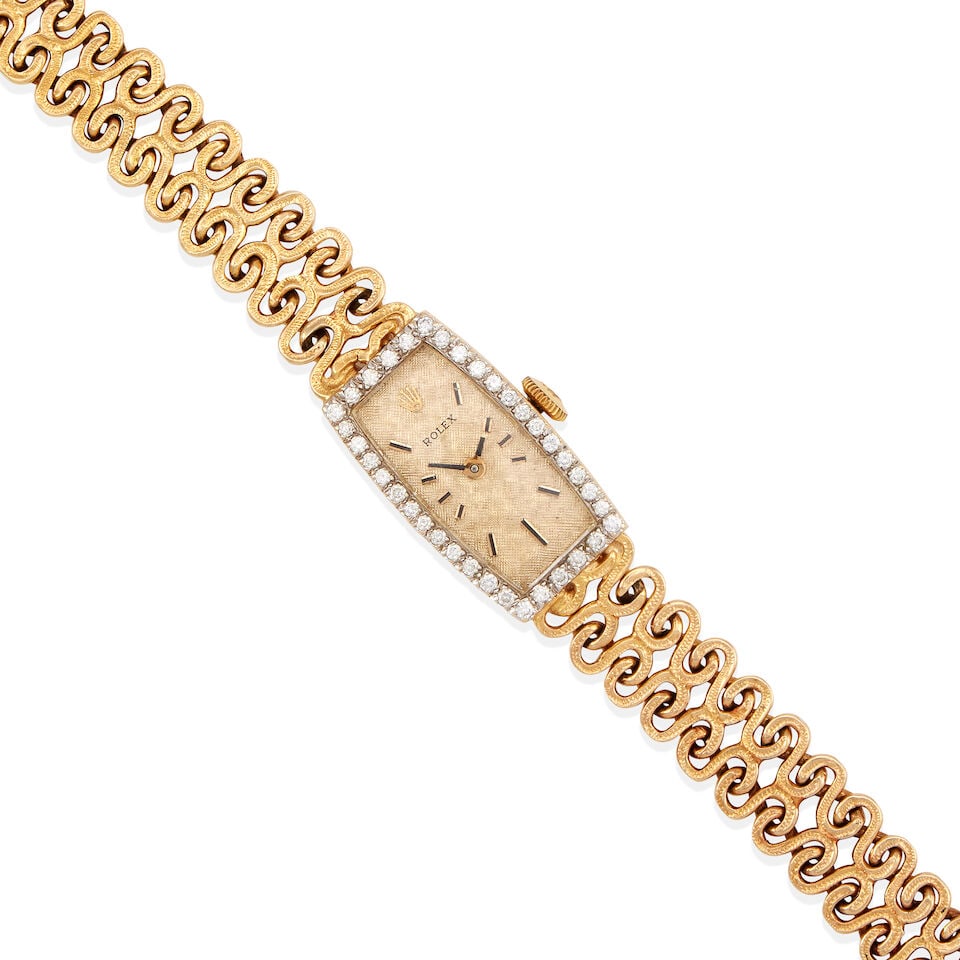 ROLEX: 14K YELLOW GOLD AND DIAMOND WRISTWATCH: ROLEX: 14K YELLOW GOLD AND DIAMOND WRISTWATCH • 14K yellow gold watch case and bracelet • Numerous round shaped diamonds weighing approximately 0.35 carat total • Signed ROLEX on